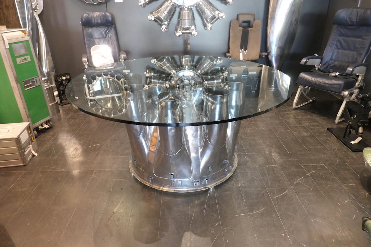 Large centre table made from a very rare aeronautical mechanical part: a stainless steel noise reducer from a Pratt & Whitney J57 engine mounted on the Boeing 707. Presented in a mirror polished finish. The glass slab is 2cm thick 160cm in diameter.