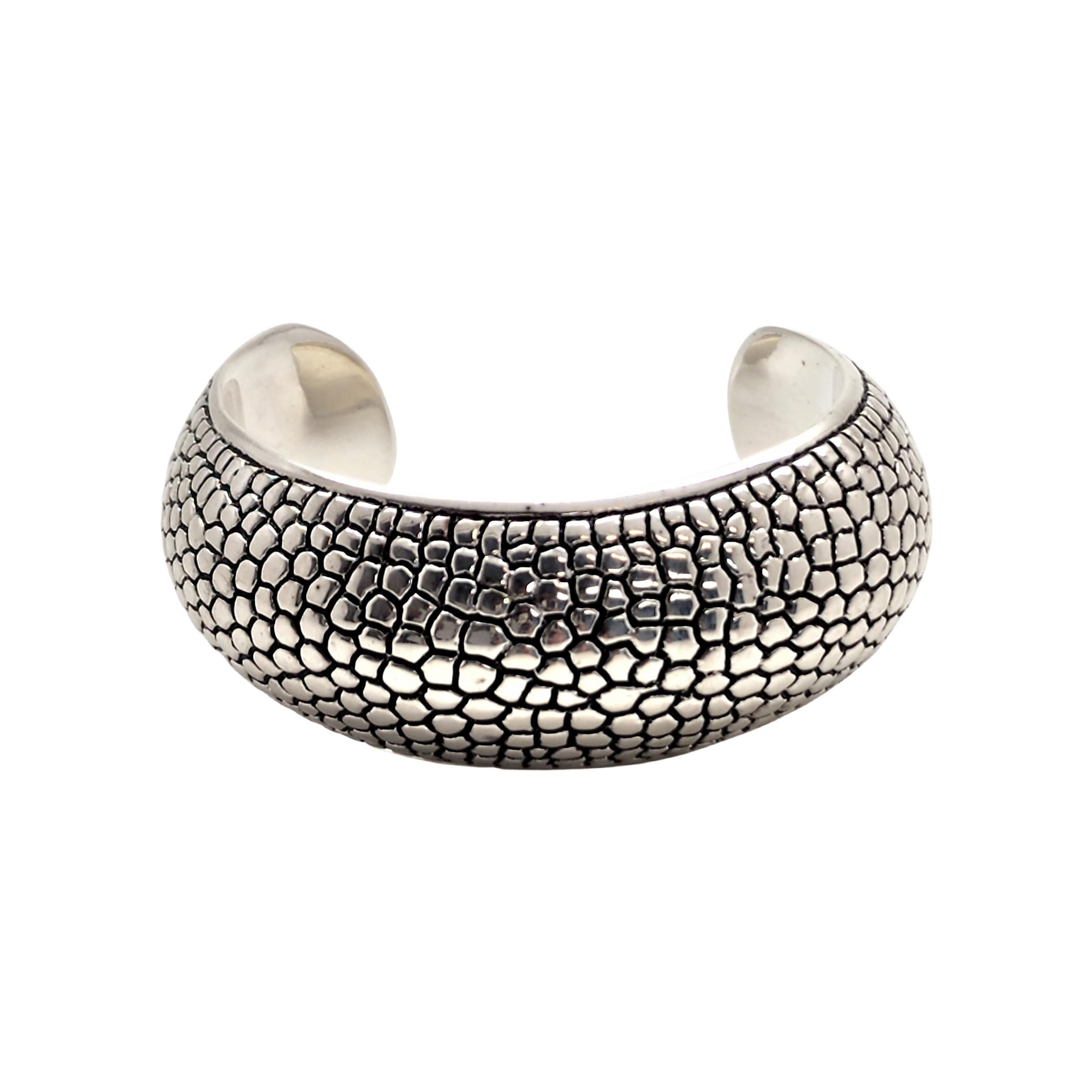Sterling silver pebble cuff bracelet by designer Airess.

Beautiful pebble design on a wide and puffy cuff bracelet.

Measures approx 5 1/2