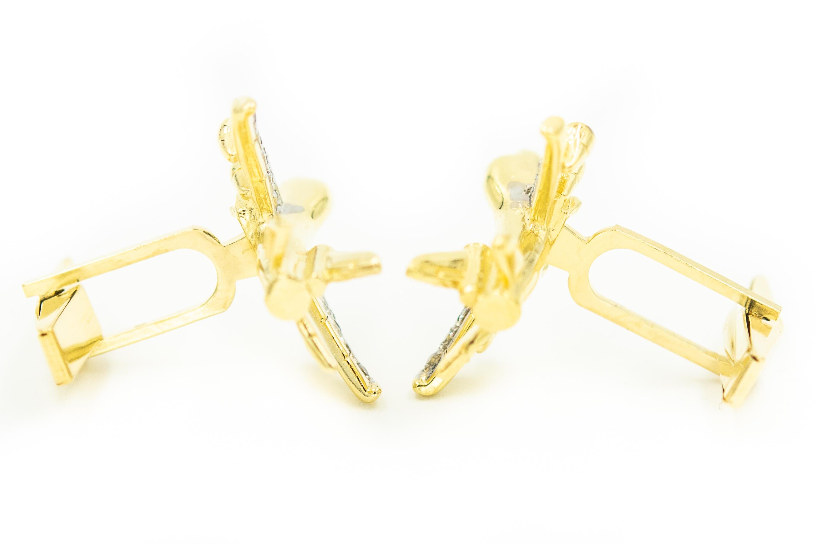 Wonderful figural 14k yellow gold airplane cufflinks featuring diamond accented wings and lights.  They have a whale t-bar closure to make it easy to put on.  A great gift for a pilot, traveler or airplane enthusiast.