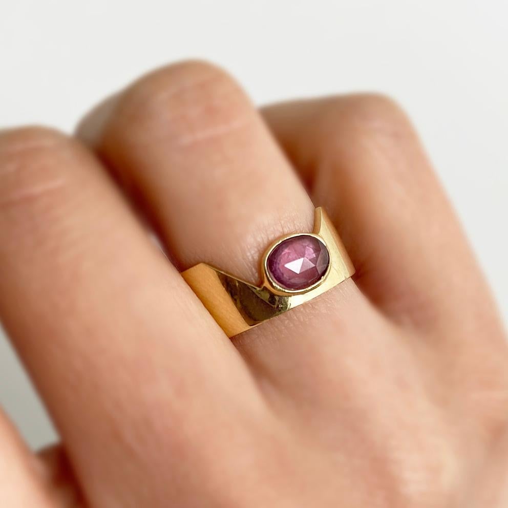 The Love More cigar ring is inspired by the bold energy and beautiful variety of skin tones. Humble crown designs play with tension, proportion and balance.

- 18K gold
- Natural rosewood pink sapphire
- Rose-cut sapphire, carat total weight 0.67
-