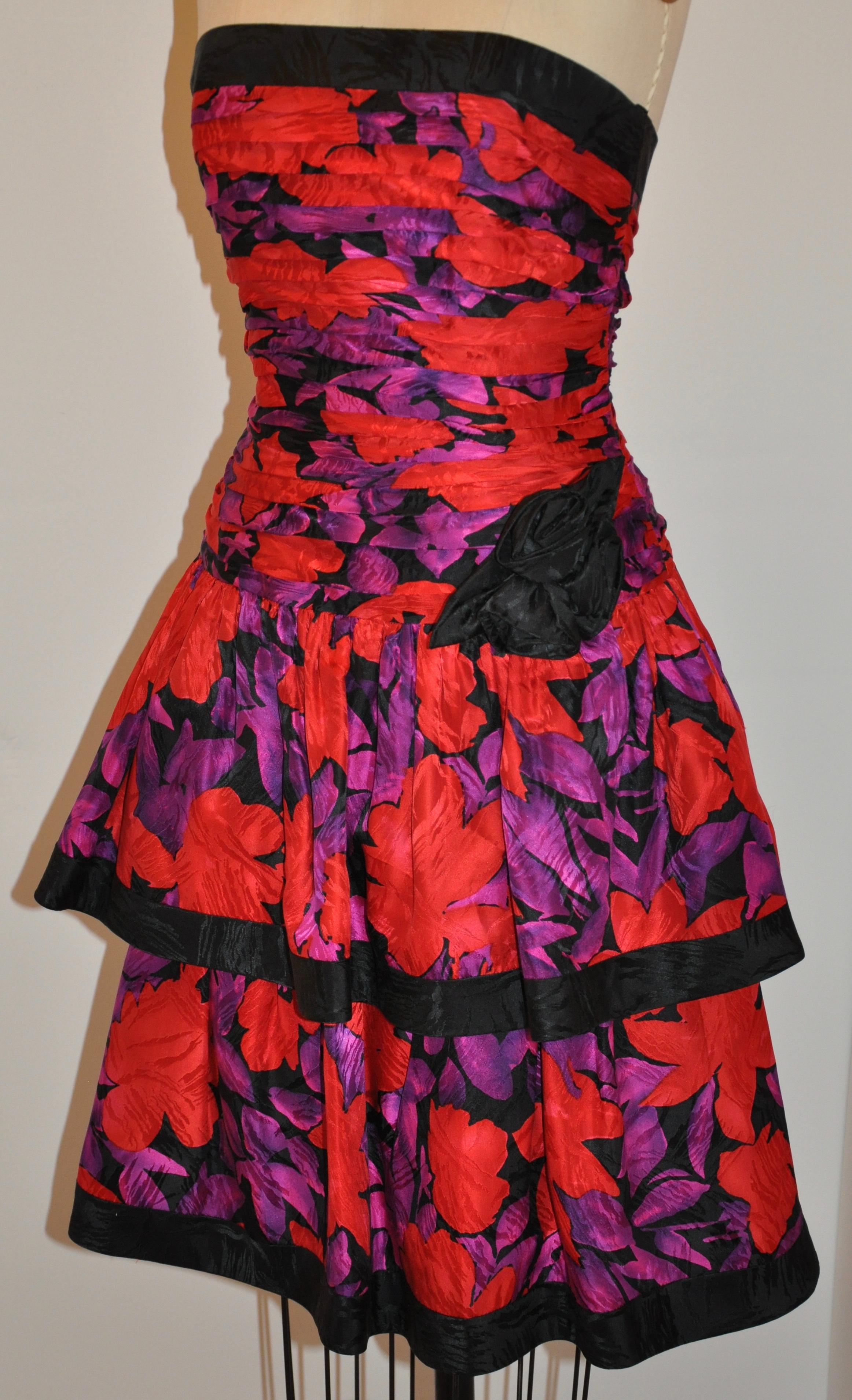          A.J. Bari wonderfully elegant silk 2-tier strapless floral print cocktail dress is fully lined with an invisible side zipper measuring 13 1/2 inches with a nook & eye on top. The bust measures 34 1/2 inches. The length in front measures 33