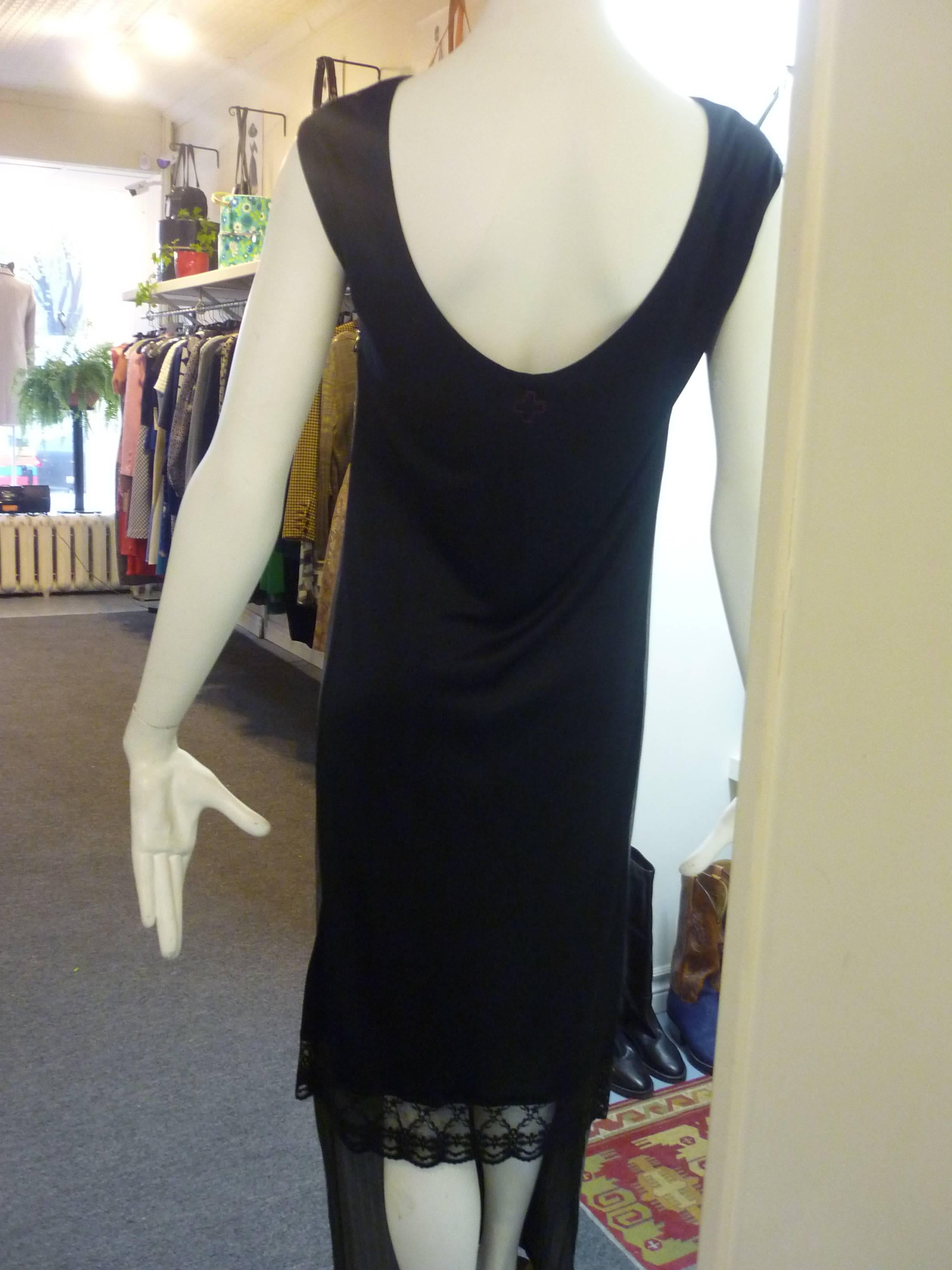 This is a very original dress in a cotton blend with a long cotton grey striped front and a black acetate/rayon shorter back with lace bottom.

It is both elegant and playful.