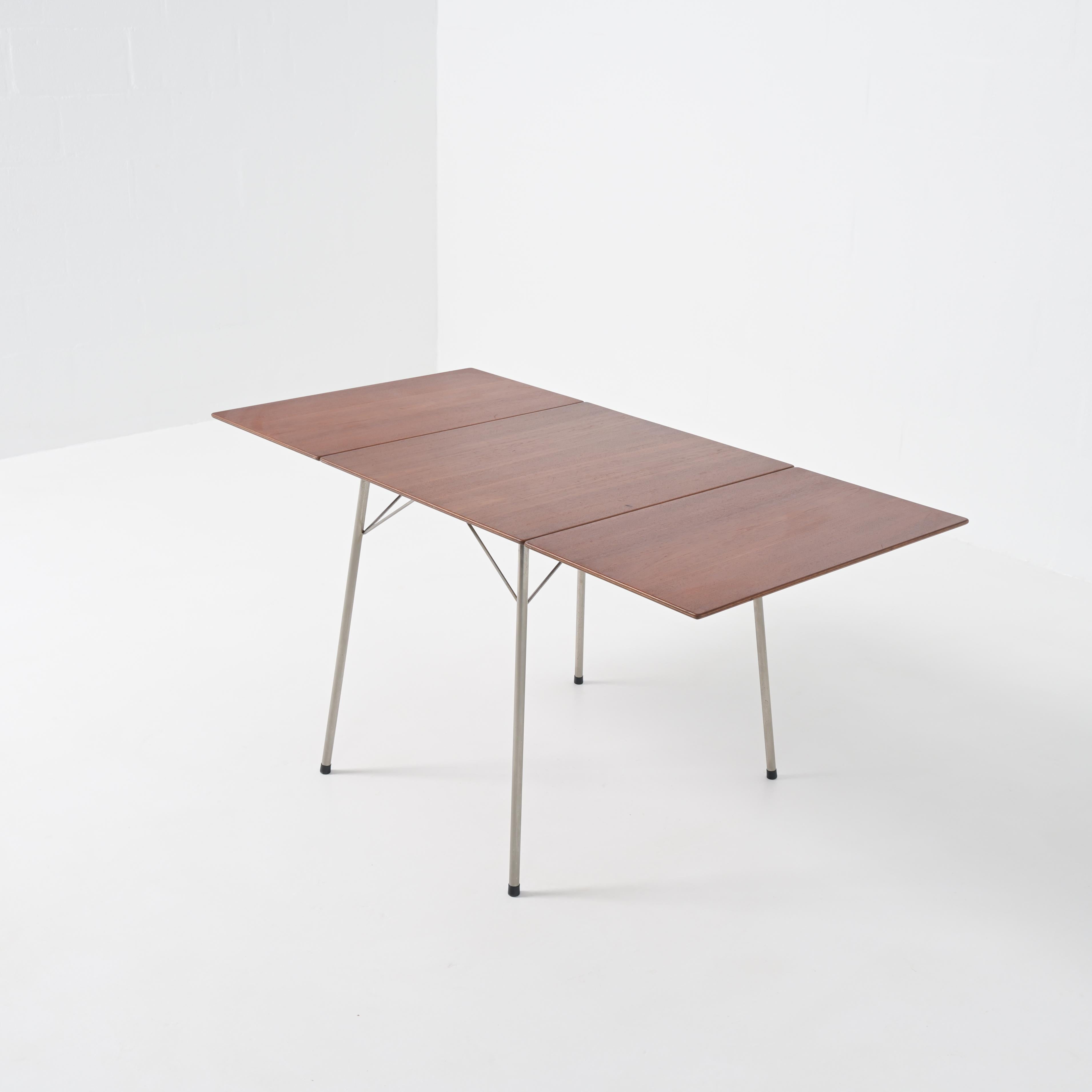 Nice small drop-leaf table model AJ3601 designed by Arne Jacobsen for Fritz Hansen, Denmark, 1952. Made to accompany his famous “ant” chairs also manufactured by Fritz Hansen in the early 1950s This table has a teak wooden foldable top and