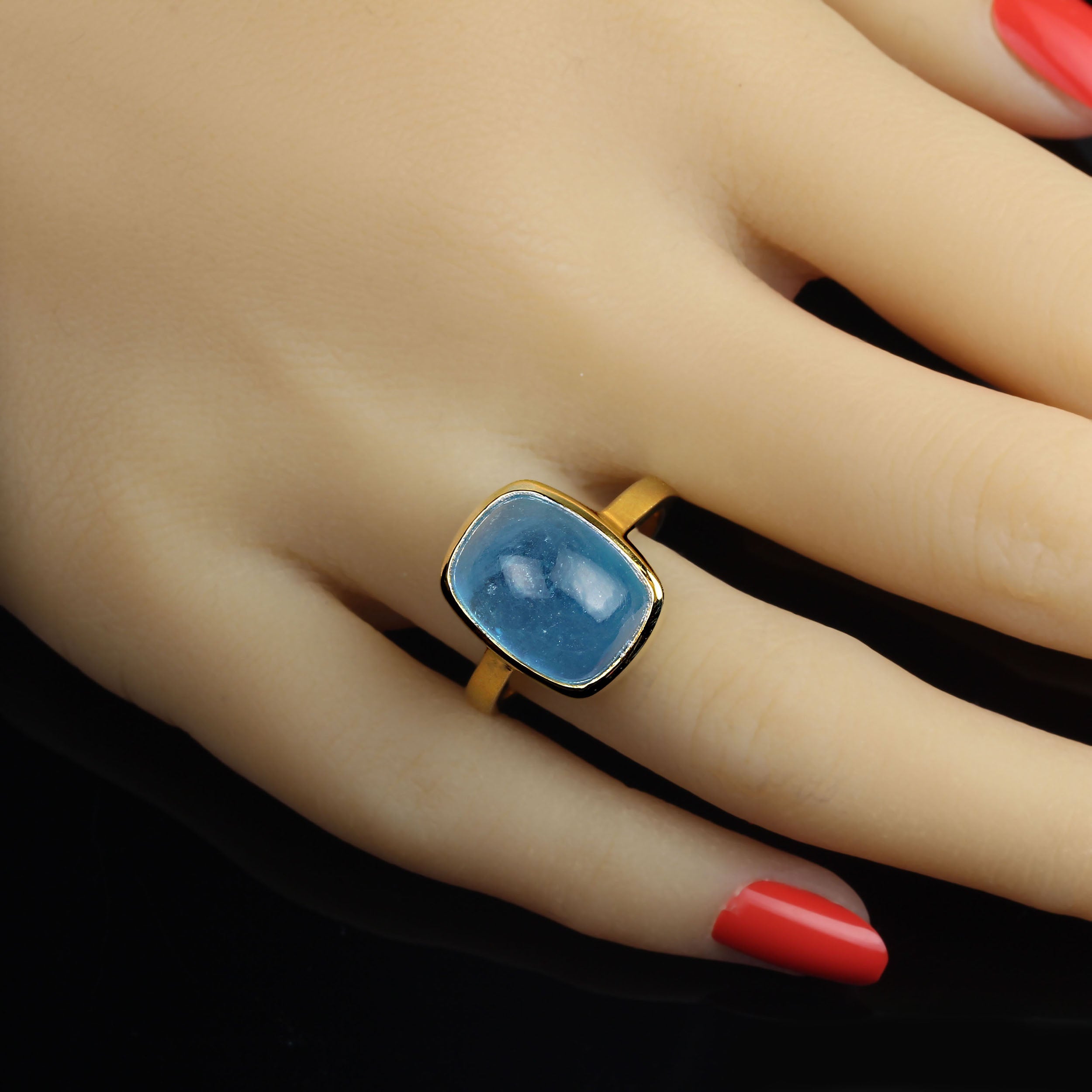 Awesome Aquamarine cabochon bezel set in gold rhodium over Sterling Silver ring.  This is a pleasing rounded rectangle shape for the gorgeous 13.51ct gemstone.  14x11mm. Aquamarine is in the Beryl family. Also, in the Beryl family you will find in