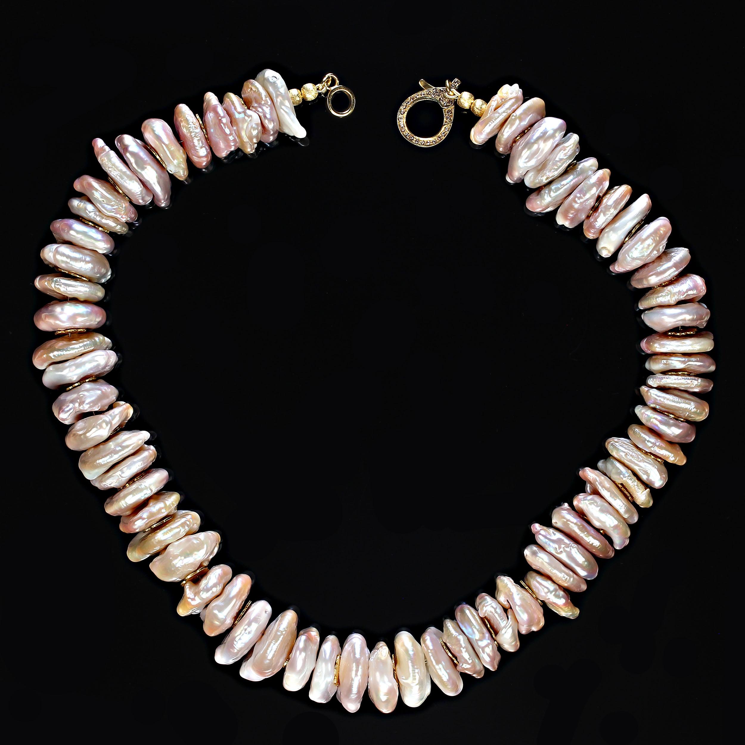 17.5 Inch necklace of center drilled 18mm light peachy/mauve coin pearls.  These gorgeous pearls are each unique and therefore don't sit perfectly together. They are iridescent and their unique shapes and bumps add to the flash of light. The gold