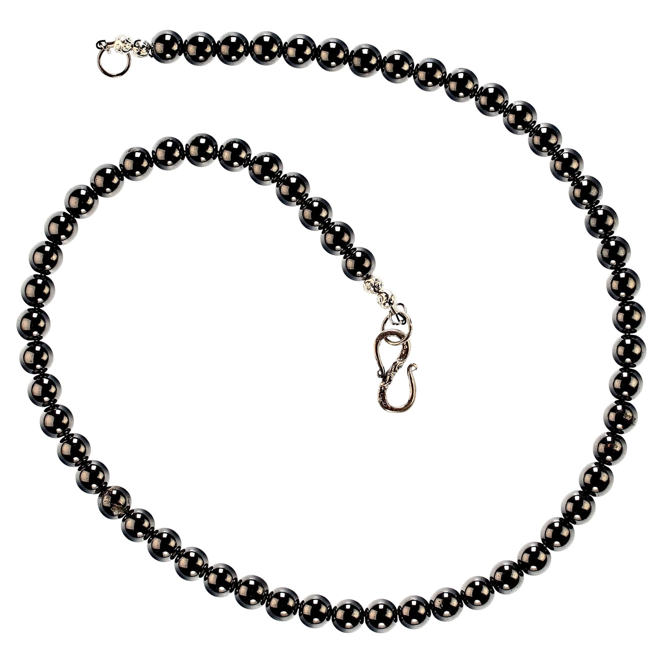 18-Inch hematite necklace with silver 'S' hook clasp.  The traditional necklace of smooth round 7MM hematite is a pleasure to wear.  Hematite is an iron oxide which polishes to bright shiny gray.  It is thought to help with stress and anxiety