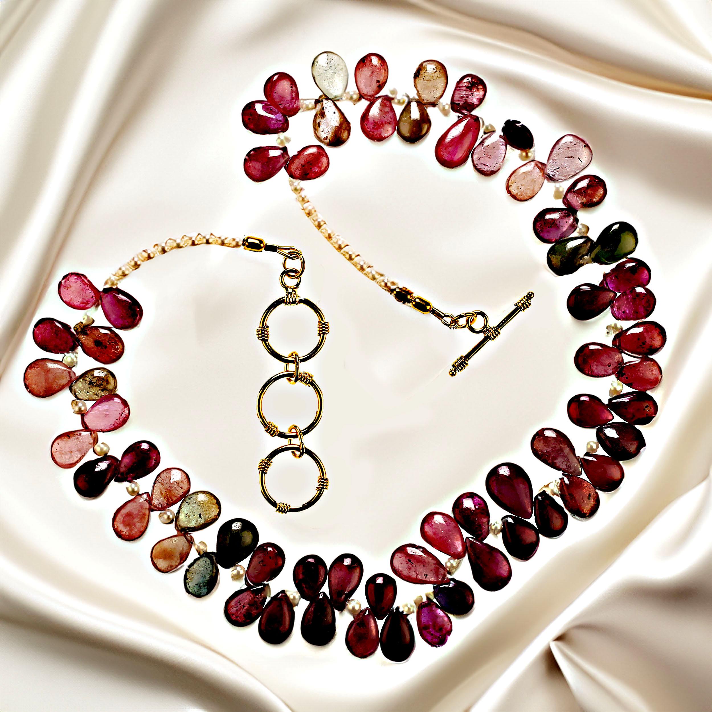 18 Inch gorgeous sapphire necklace in smooth briolette that graduate 11-13.5mm in predominately pinks and deep reds, with accents of white seed pearls.  This unique necklace is secured with a gold plate three ring expandable toggle clasp.  MN2361