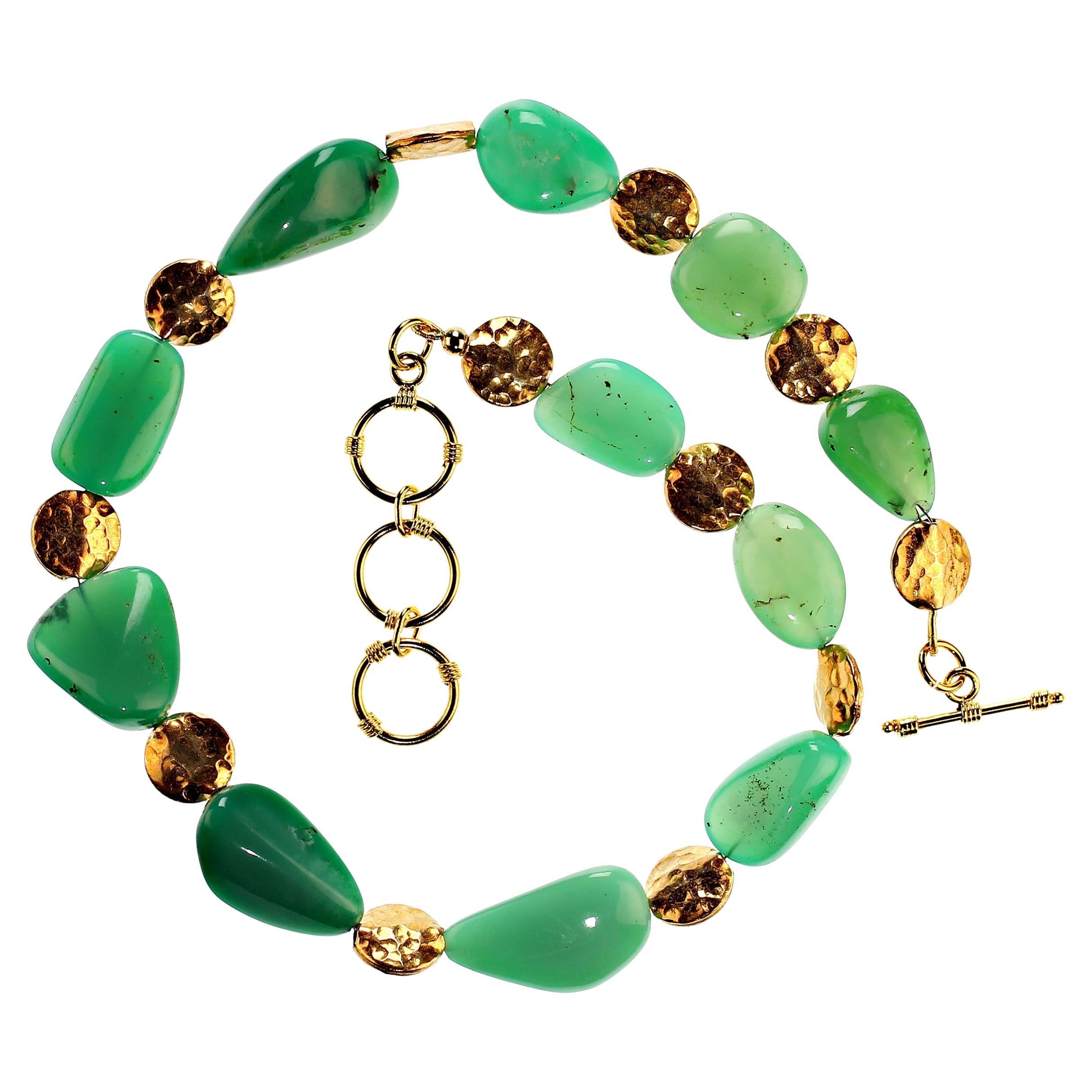 18 Inch necklace of gorgeous slightly graduated highly polished green chrysoprase nuggets accented with goldy round hammered discs.  This lovely necklace is secured with a gold-plate three ring toggle clasp. MN2345