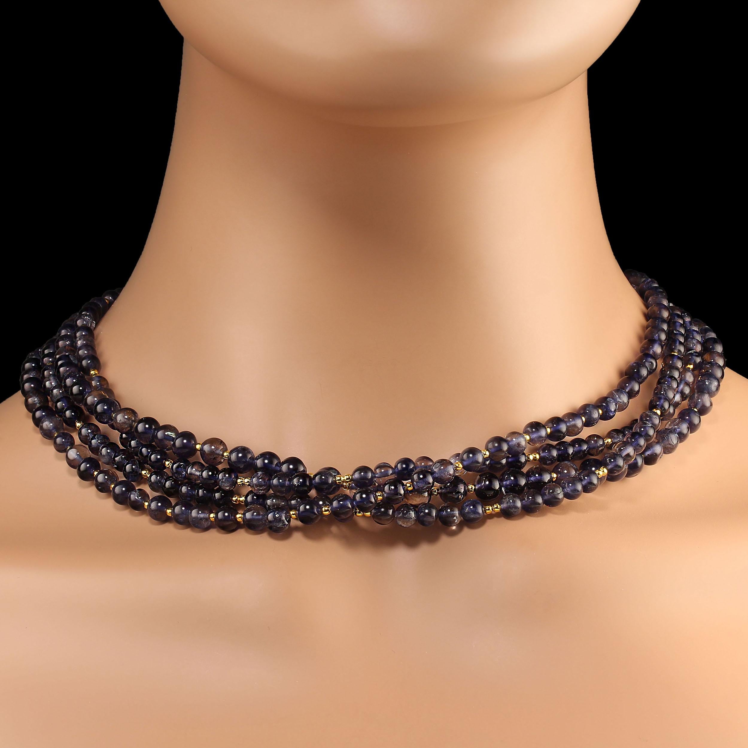 18-Inch necklace of blue iolite 5-6 mm highly polished smooth beads.  Iolite is a rare gemstone being trichroic. Depending on the angle from which it is viewed it can appear blue, gray, or straw (yellowish).   Each of these four strands has slightly