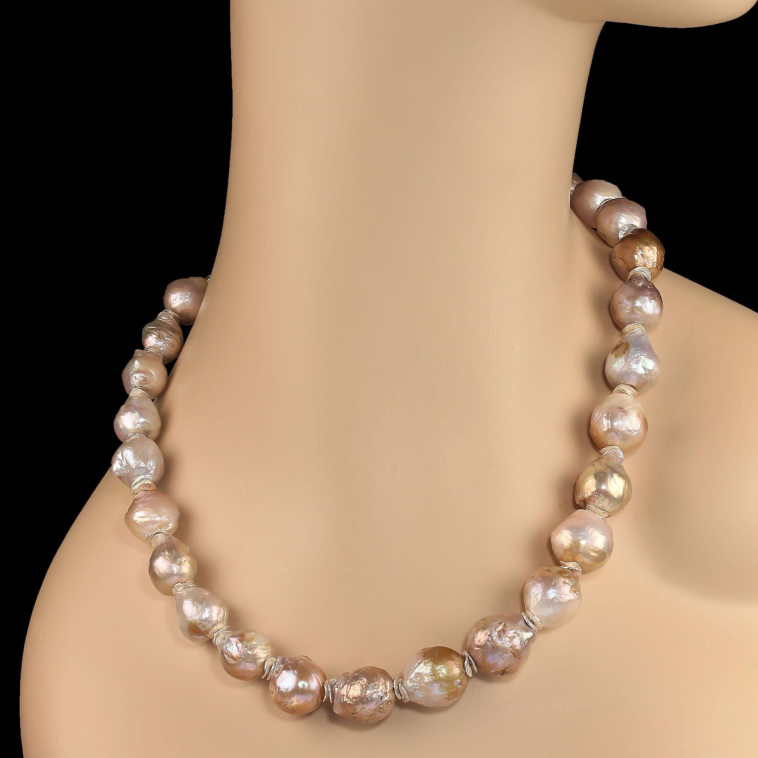 Elegant 19-inch cocktail or dinner party necklace. This necklace is 11-15 MM silvery iridescent baroque pearls with touches of gold and mauve. The silvery flutters accent the silvery tone of the pearls. This 19-inch necklace is secured with a 'S'