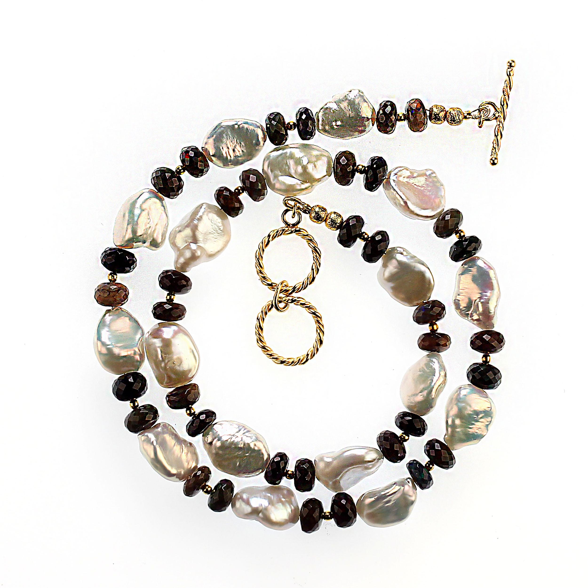 Elegant and always stylish, this 19-inch black and white necklace is perfect for all occasions. The black opal rondels flash pinks and greens. These lovely second harvest keshi pearls iridesce flashes of pink and yellow. Tiny goldy accents sit