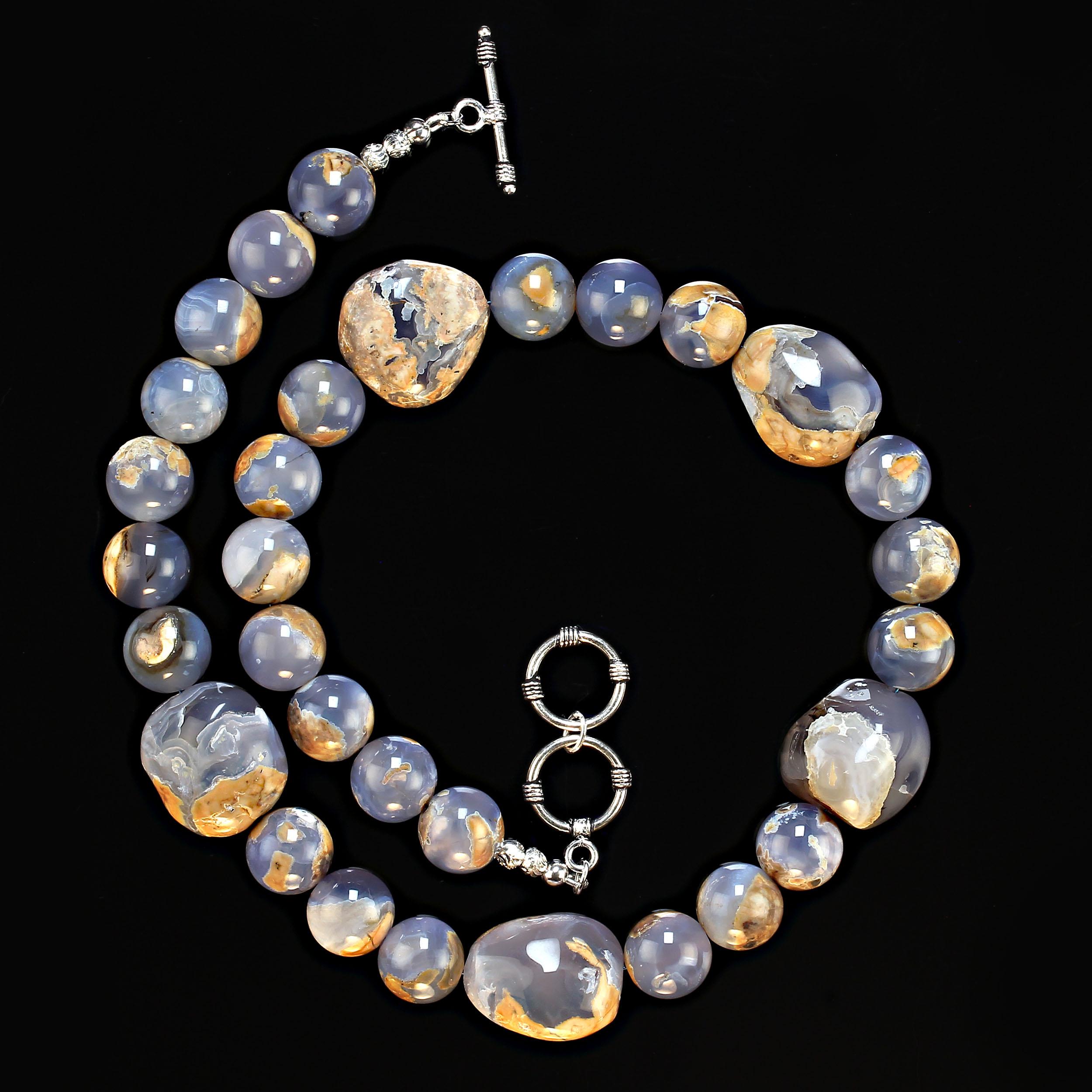 I9 Inch necklace of highly polished 13mm blue chalcedony with matrix.  This necklace features five additional blue chalcedony nuggets, each one is unique and fascinating.  The necklace is secured with a two-ring silver plate toggle clasp.  MN2353