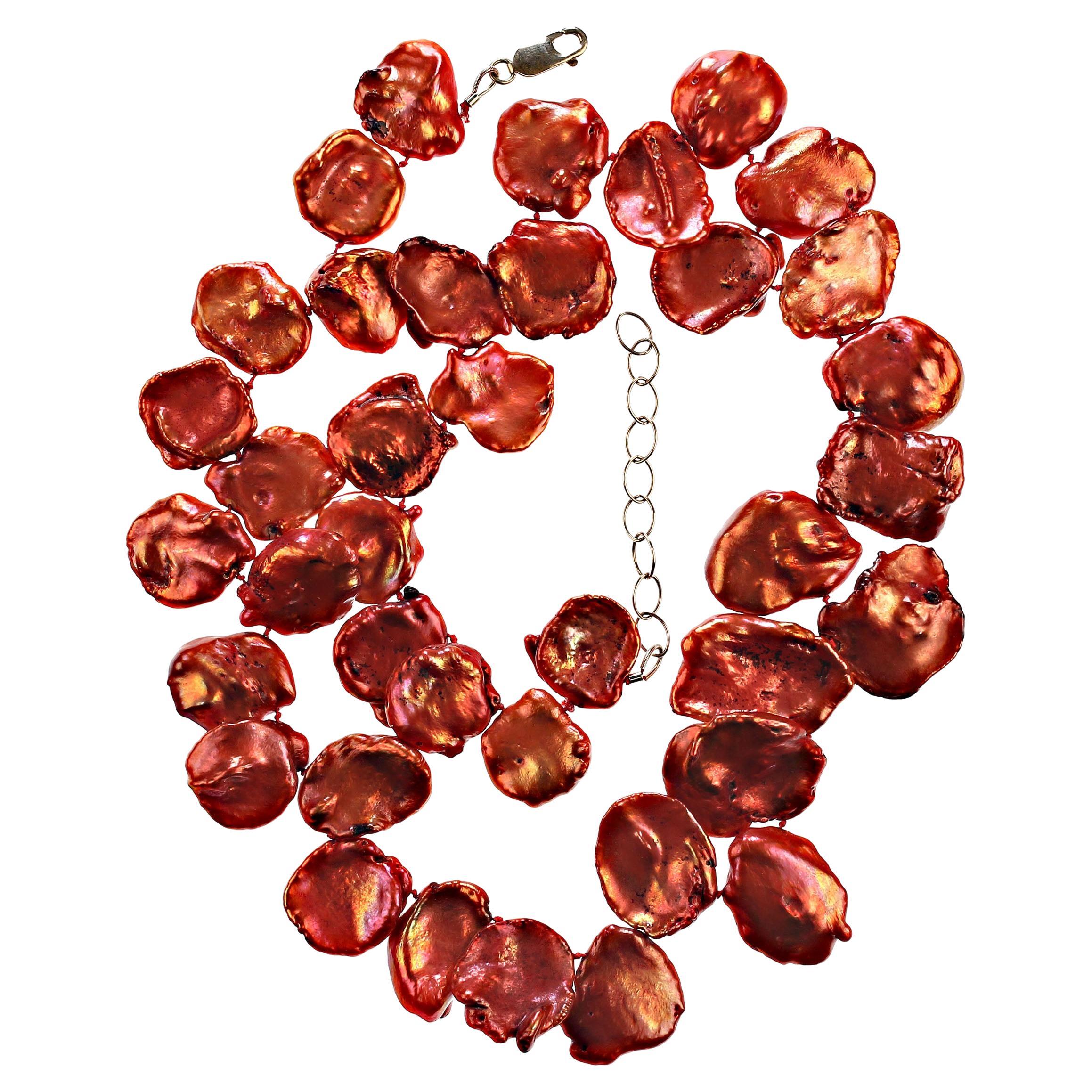 Graduated Flat Keshi Pearl necklace in lovely shades of burnished orange.  This unique hand knotted pearl necklace is 19 inches in length. The pearl colors range from orangey red to orange and purple. Pearl is the June birthstone, but don't wait