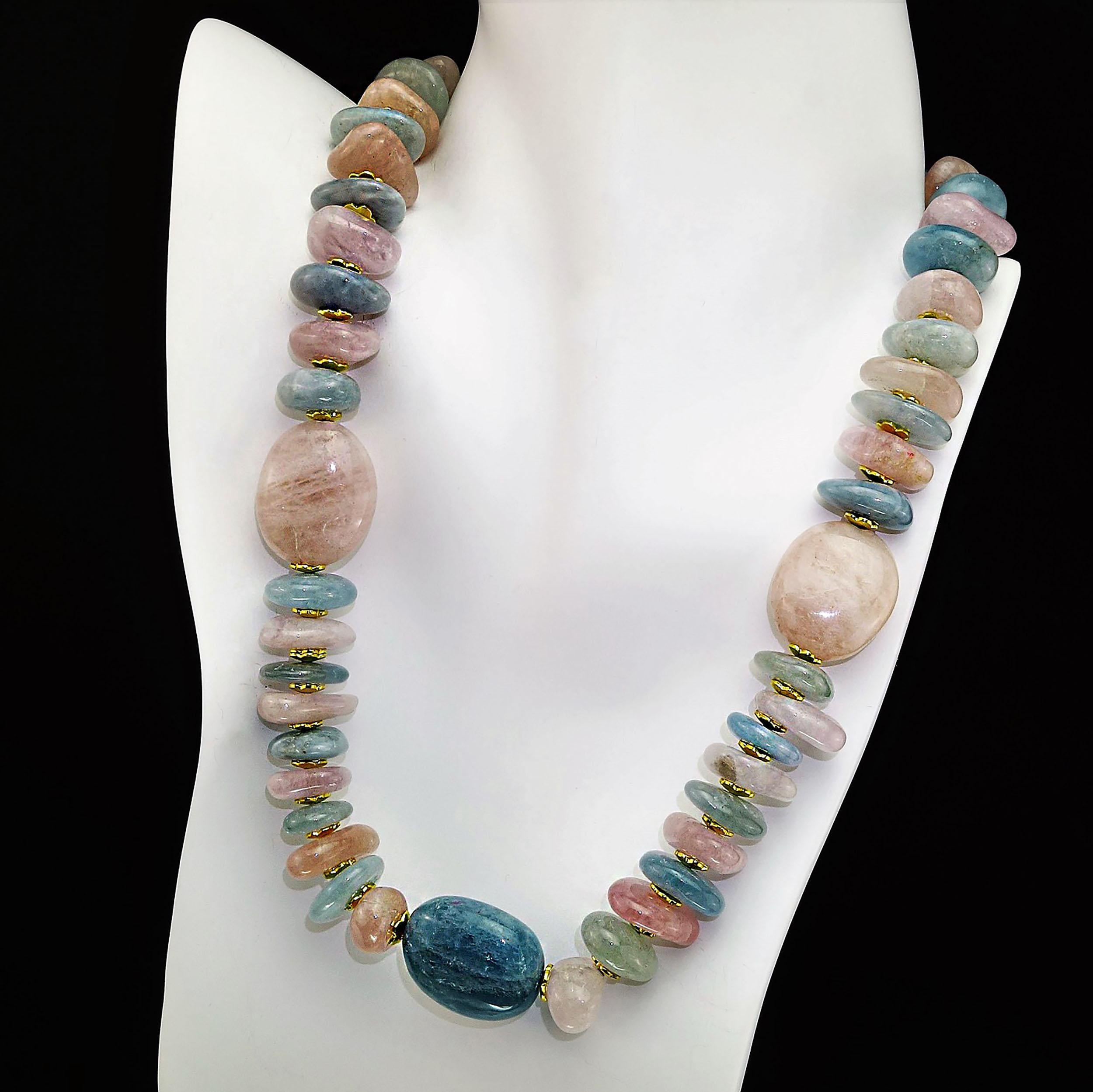 Necklace of glowing polished tumbled rondelles of Pink Morganite and Blue Aquamarine with focals of larger flat tablets of same. The polished tumbled rondelles (12-20mm in size) alternate in color and are enhanced with gold tone fluted spacers. A