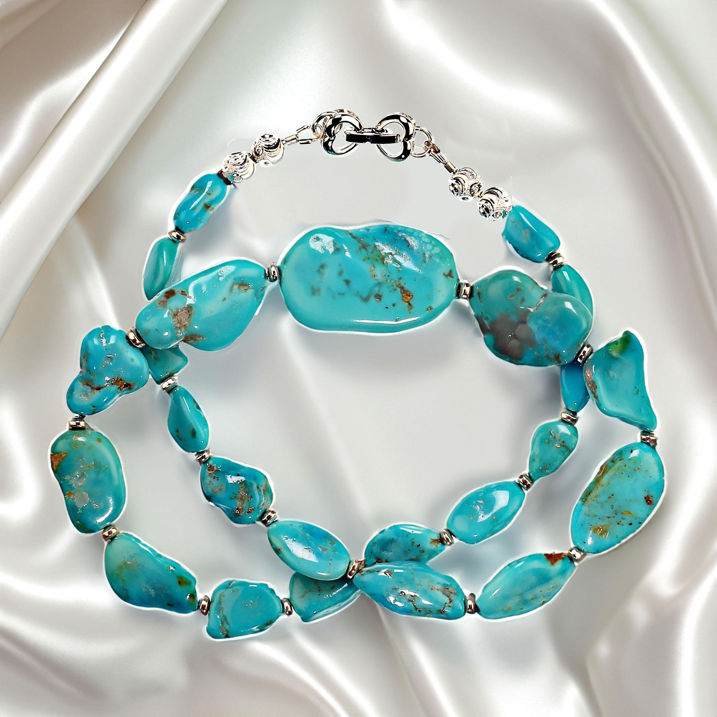 Elegant necklace of Sleeping Beauty Turquoise flat nuggets with silvery accents and a charming double heart clasp. The nuggets graduate from 11 to 32MM.  This 19-inch necklace is the perfect Sleeping Beauty color from the world-famous Sleeping