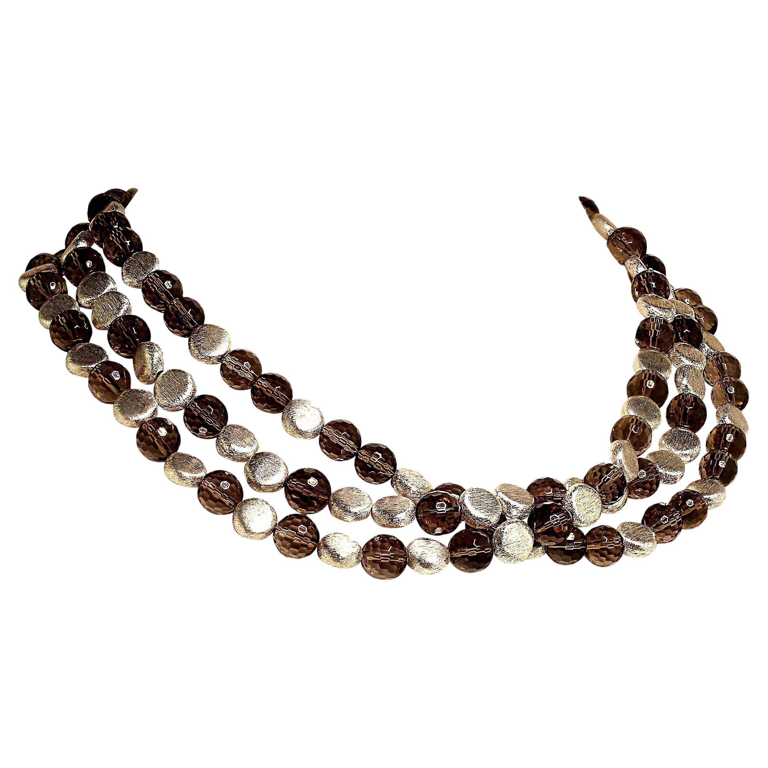 Unique three strands of sparkling, 10 MM round faceted Smoky Quartz interspersed with frosted silver tone discs necklace. These medium tone Smoky Quartz are very bright and sparkly. The three strands can be gently twisted for a completely different,