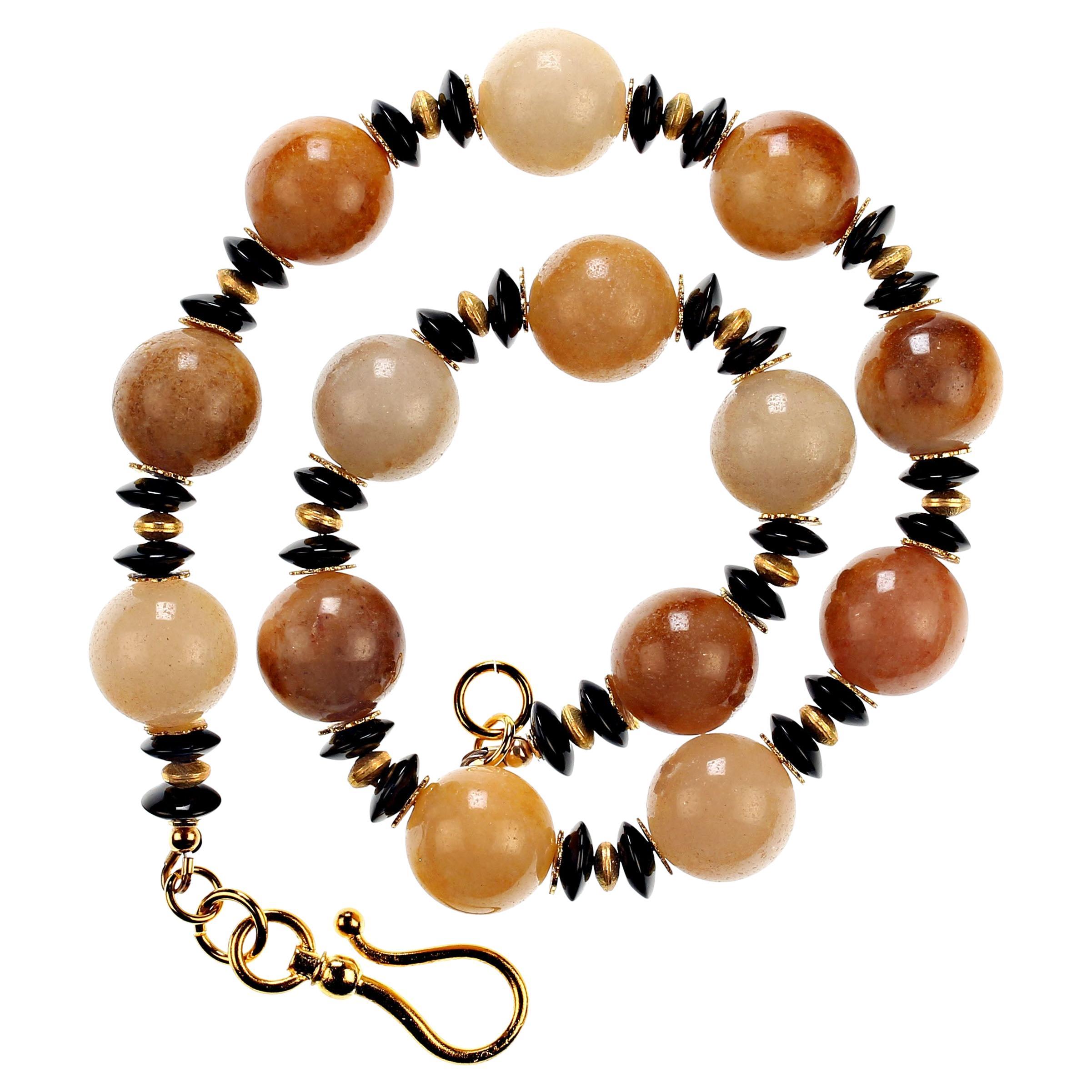 Gorgeous Large highly polished Golden Jade, 18 MM, accompanied with rondelles of glistening Black Tourmaline, 10 MM, and golden accents.  The Golden Jade is a wonderful variety of dyed warm shades that are enhanced by the highly polished Black