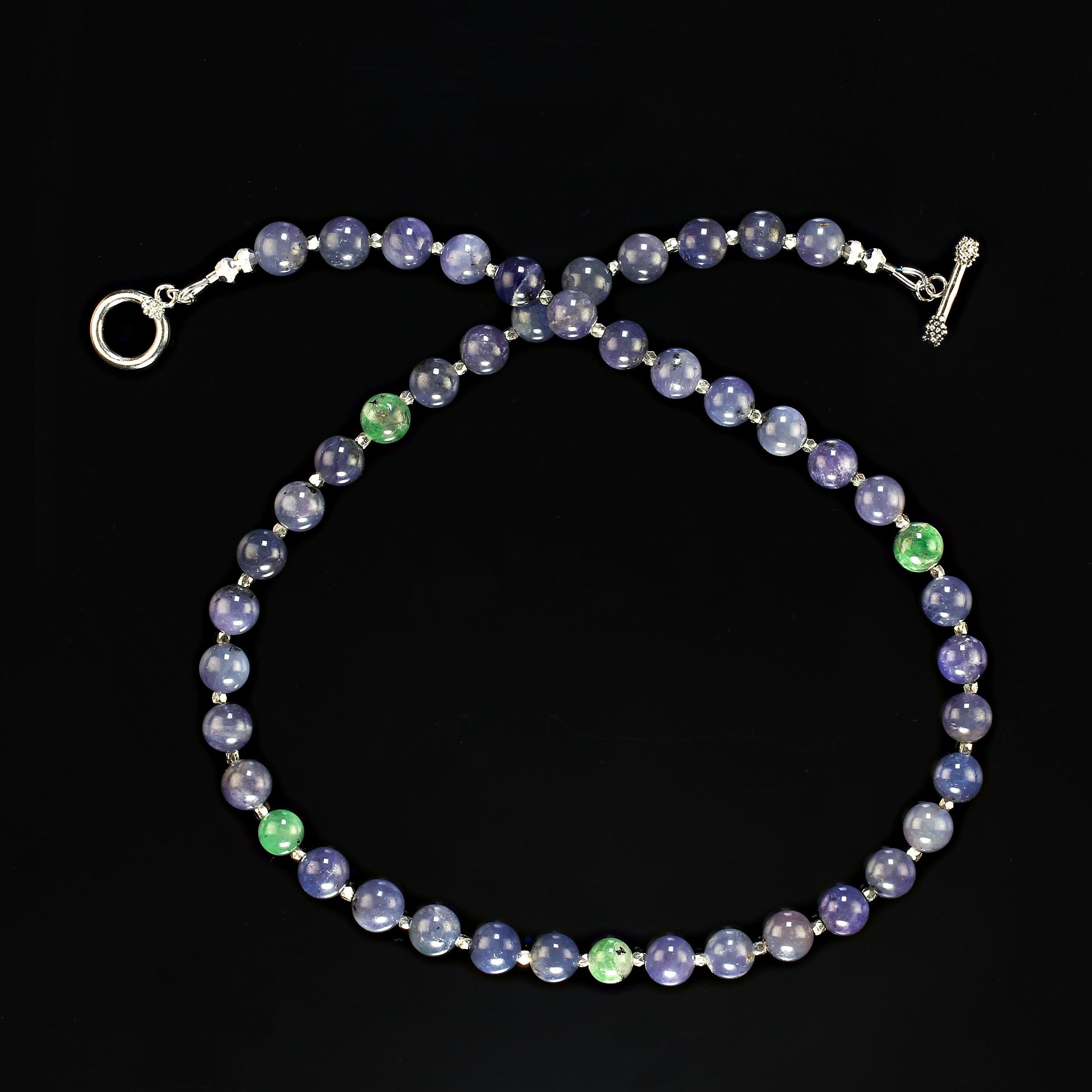 20 Inch unique translucent tanzanite shades of purple/ blue and green.  These unusual colors are combined with faceted fine silver accents to create a one-of-a-kind necklace the will intrigue and delight you. The 8mm tanzanite a smooth and highly