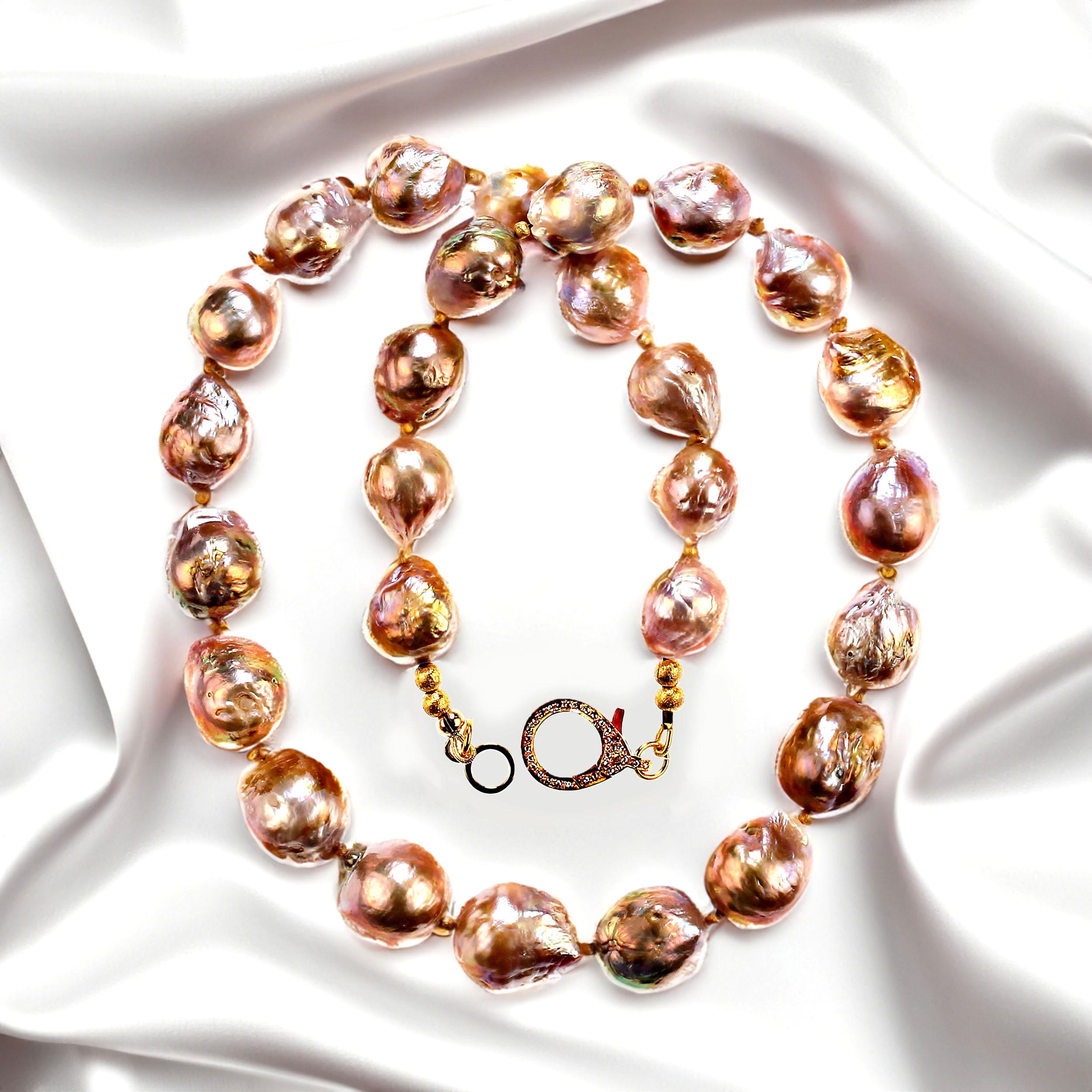 21 Inch elegant baroque pearl necklace with goldy accents.  These gorgeous 11-15 mm gold pearls feature pink and blue flashes.  The necklace is secured with a lobster claw clasp with diamond chips. 
 MN2357