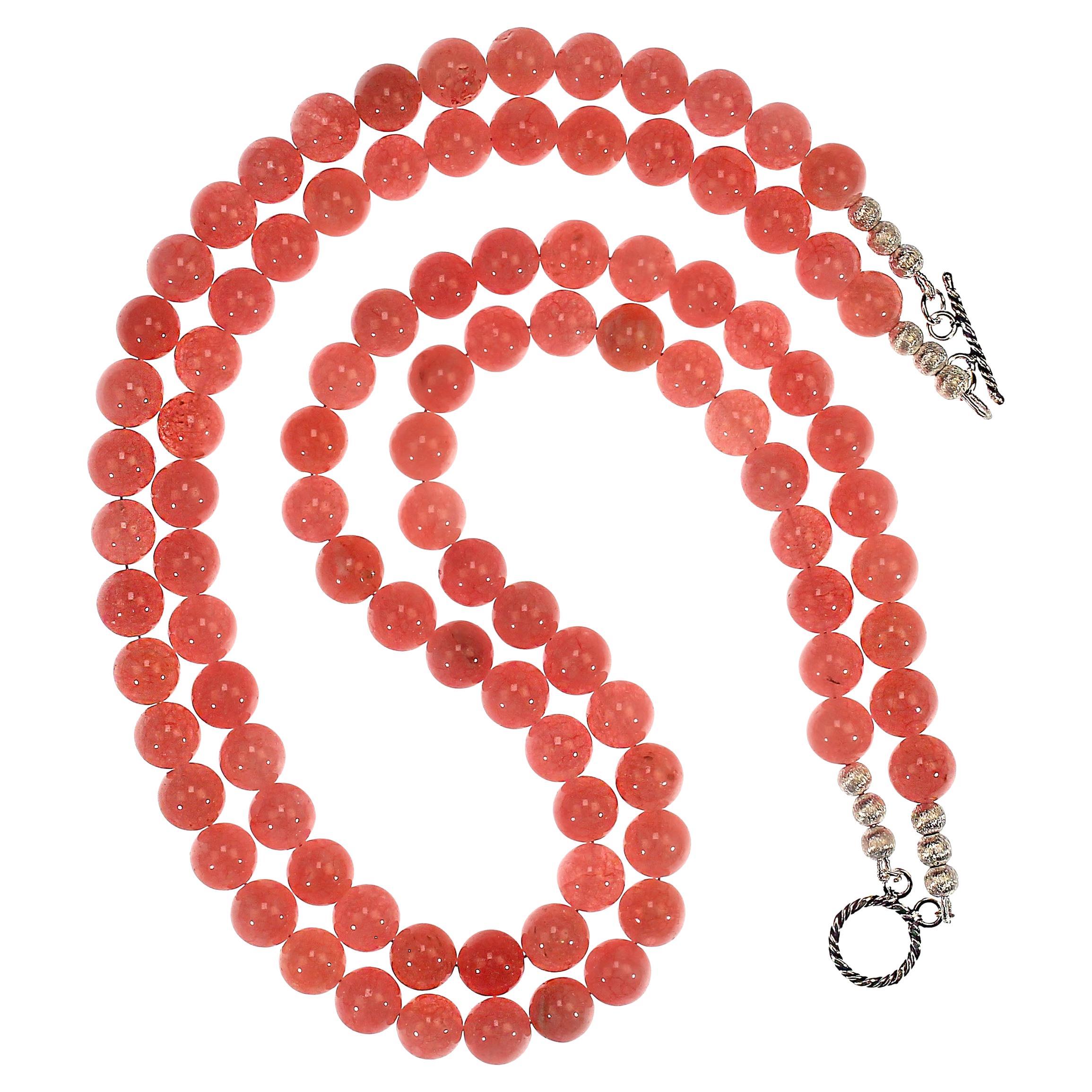 This beautiful 21-inch two-strand necklace features smooth, highly polished agate beads in soft peachy-pink tones that glow with subtle translucence. Each 10 mm agate bead offers a delicate blend of warmth and light, creating a soothing, feminine