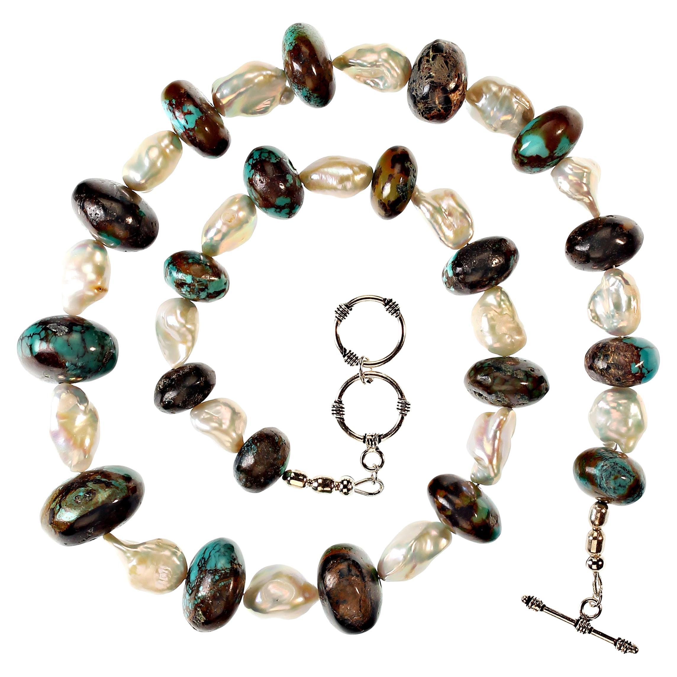 22 Inch necklace of graduated rounded rondelles of Hubei turquoise (up to 23mm) mixed with white freshwater pearls. The pearls have gorgeous luster with flashes of pink and blue. The necklace is secured with a silver-plate two loop toggle for easy