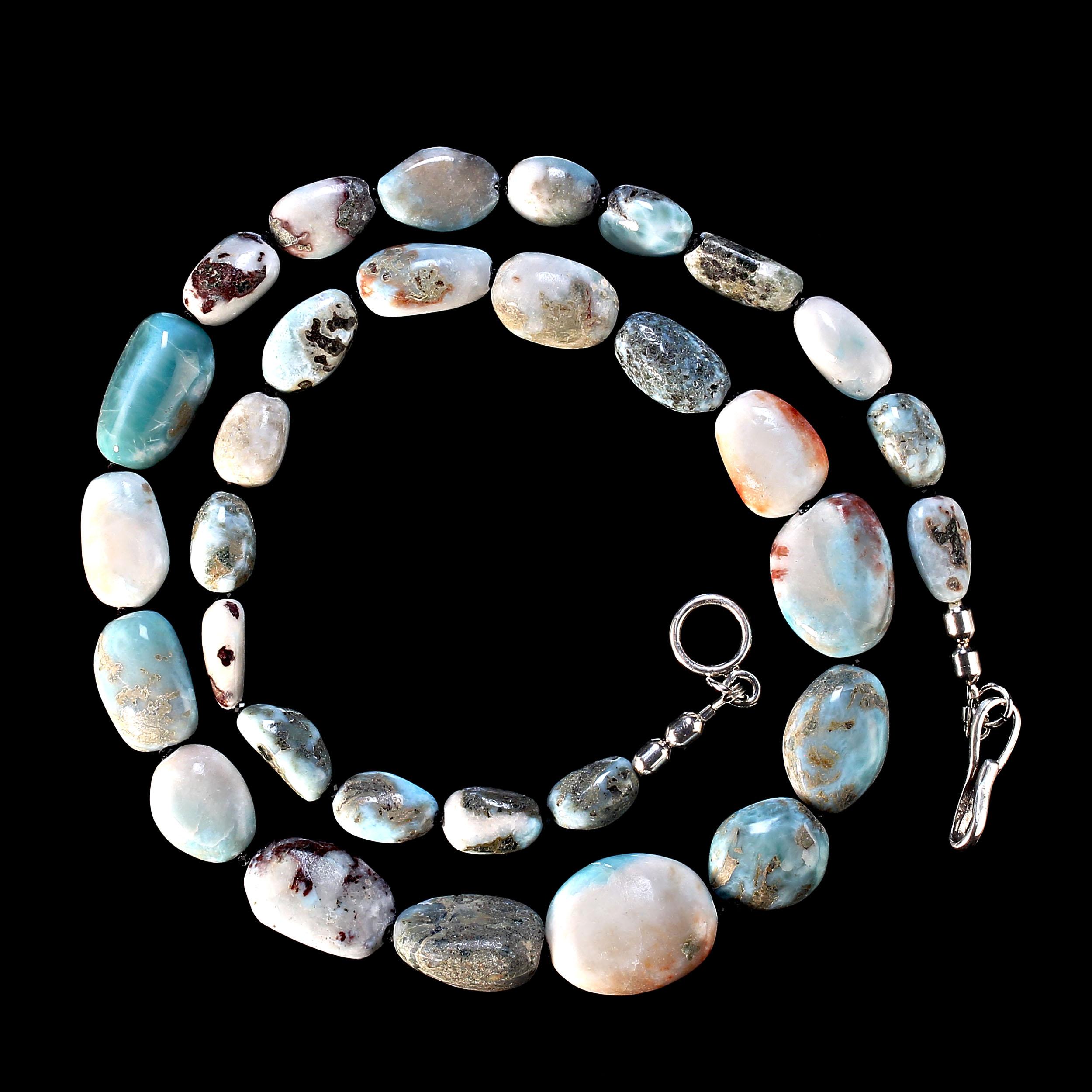 23 Inch polished graduated, 13 to 23MM, Larimar necklace with a silver hook and eye clasp. This is lovely Larimar, each gemstone is unique with blue, white, gray, and brown features. Larimar is an opaque gemstone only found around the town of