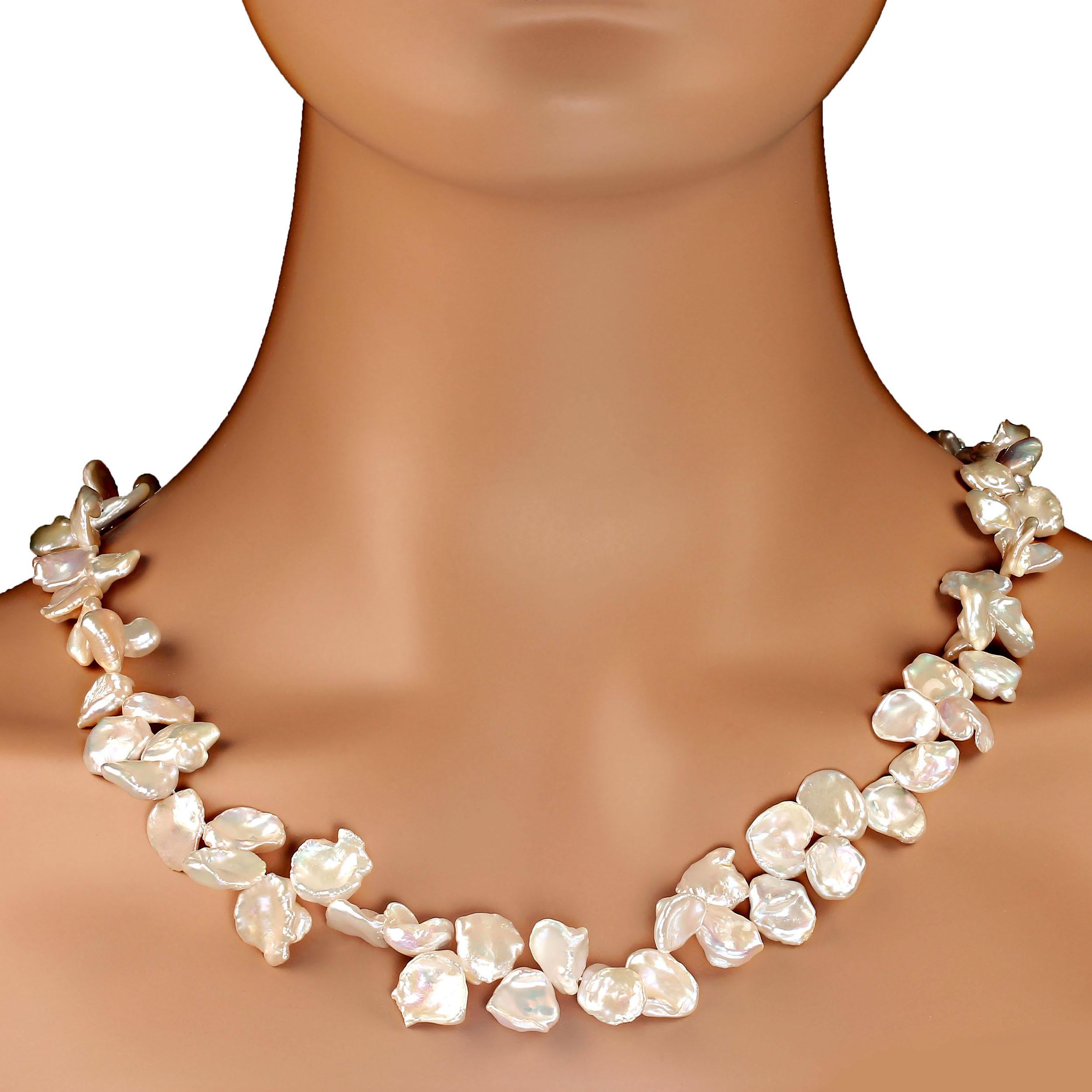 23 Inch White Iridescent Keshi Pearl necklace that is gently graduated from 9 to 14 mm.  These flatish, roundish gorgeous pearls are such a pleasure to wear. They glow and iridesce and create quite a presence.
The necklace is secured with an