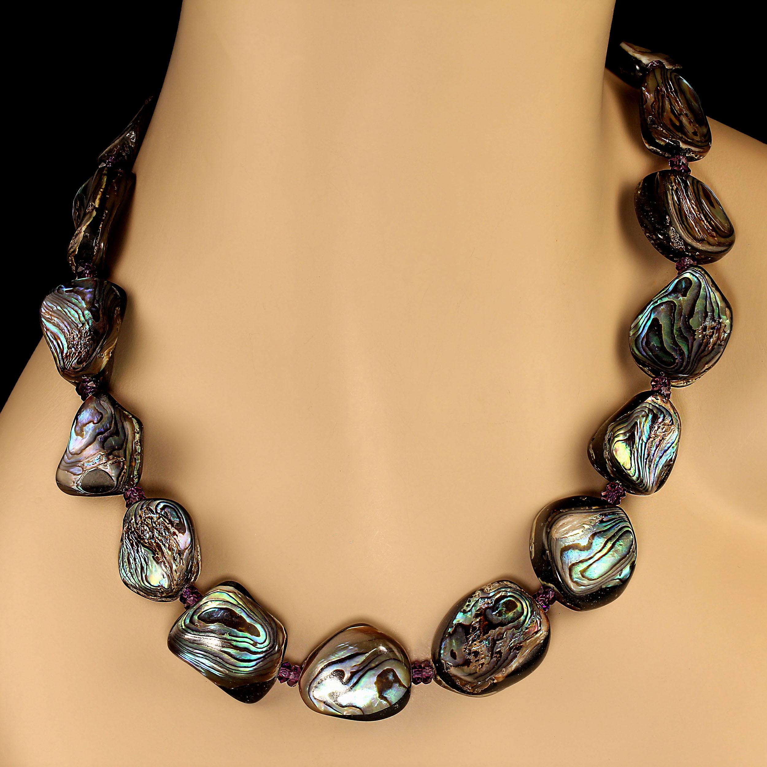 Organic shapes of double-sided abalone shell accented with sparkling amethyst necklace. This dramatic 24-inch necklace is light weight and sits beautifully at the neckline.  The abalone shell iridesces with shades of green, blue, and purple. The