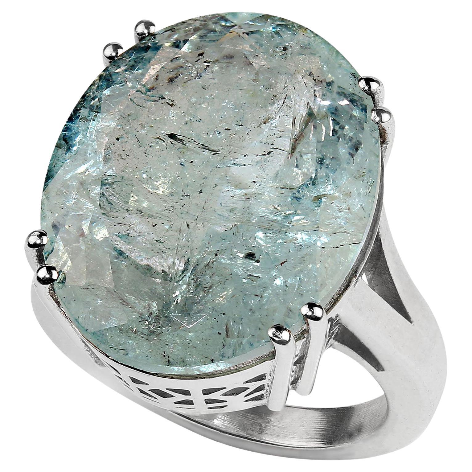 Elegant Cocktail ring of huge blue-green Beryl set in a custom made Sterling Silver setting. This 25ct gemstone features all the usual inclusions found in the beryl family. Also, in the Beryl family you will find in addition to aquamarine, emerald,