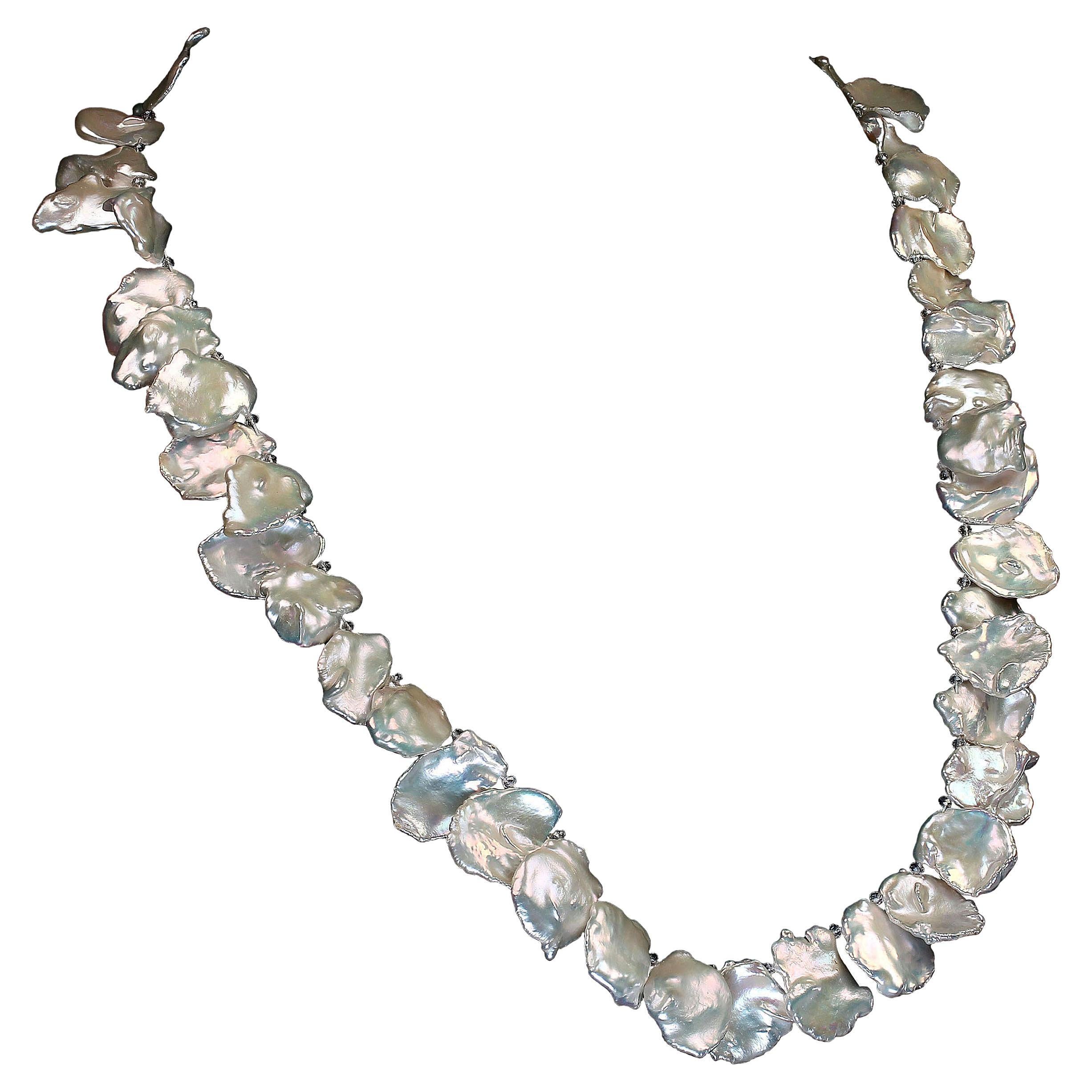 Own the jewelry you desire

Stunning, white, iridescent, graduated Keshi pearl necklace with Silver Topaz accents. This unique 26 inch necklace features Keshi pearls which resemble corn flakes up to 20mm.  This one of a kind, handmade necklace is