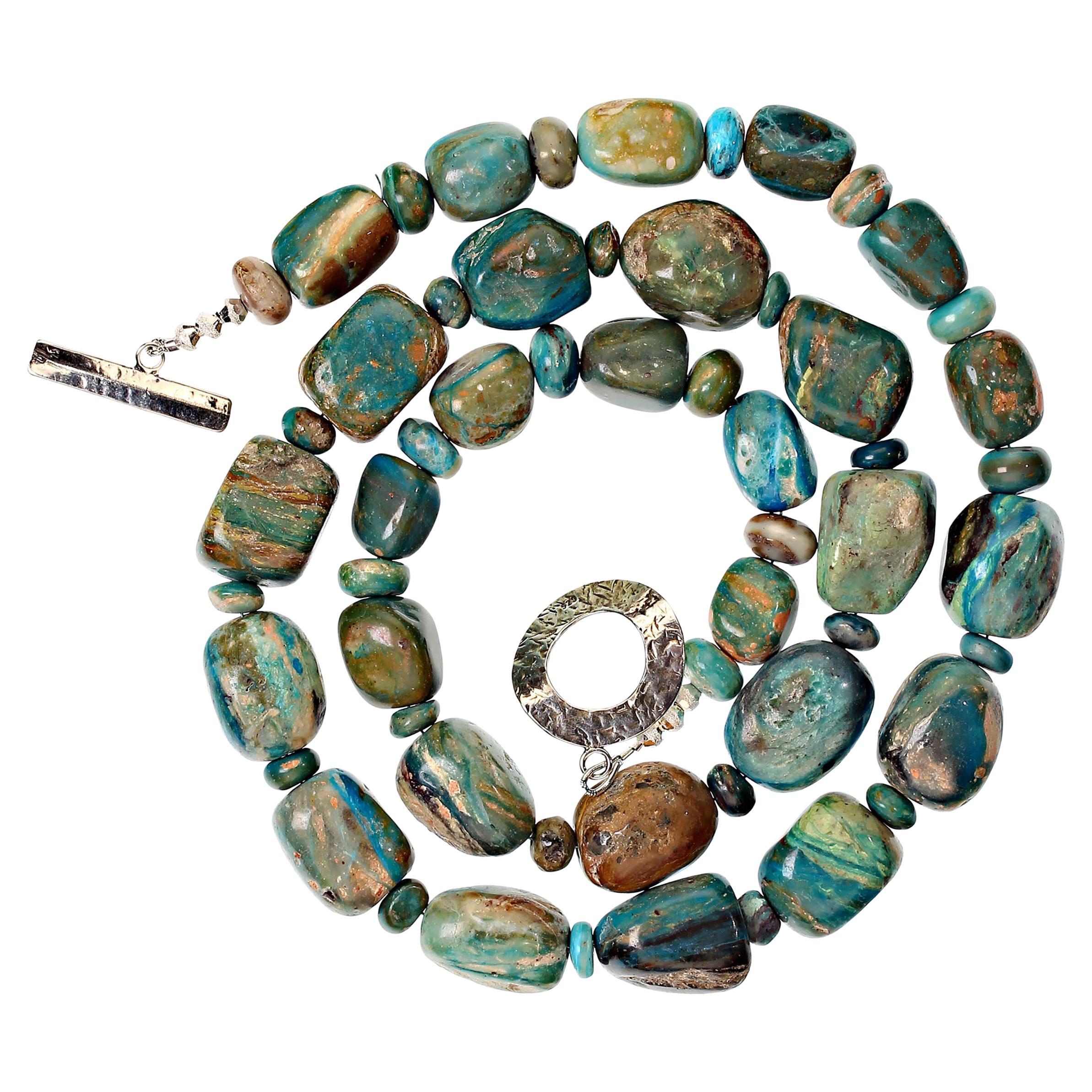 Unique blue Peruvian opal nugget necklace with hammered Sterling Silver toggle clasp. Each nugget is unique and colorful exhibiting blue, tan, gray, brown, and green, all in various shades.  The nuggets are gently graduated and spaced with rounded