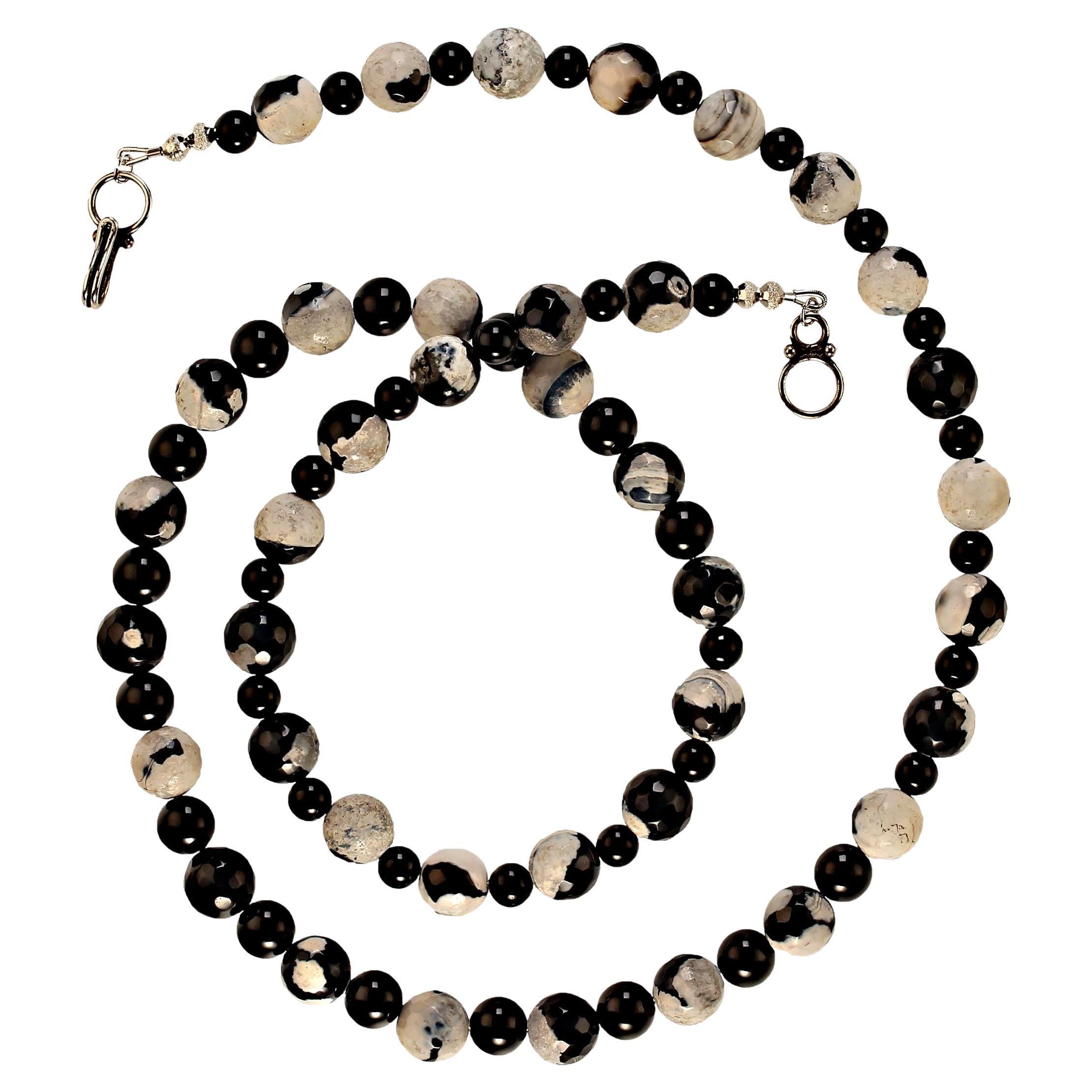 29 Inch modern looking black and white necklace of fire agate and black onyx.  The 10mm fire agates are mottled black and white. They are accented with smooth highly polished black onyx in both 8 and 6 mm. Black and white is a modern and yet always