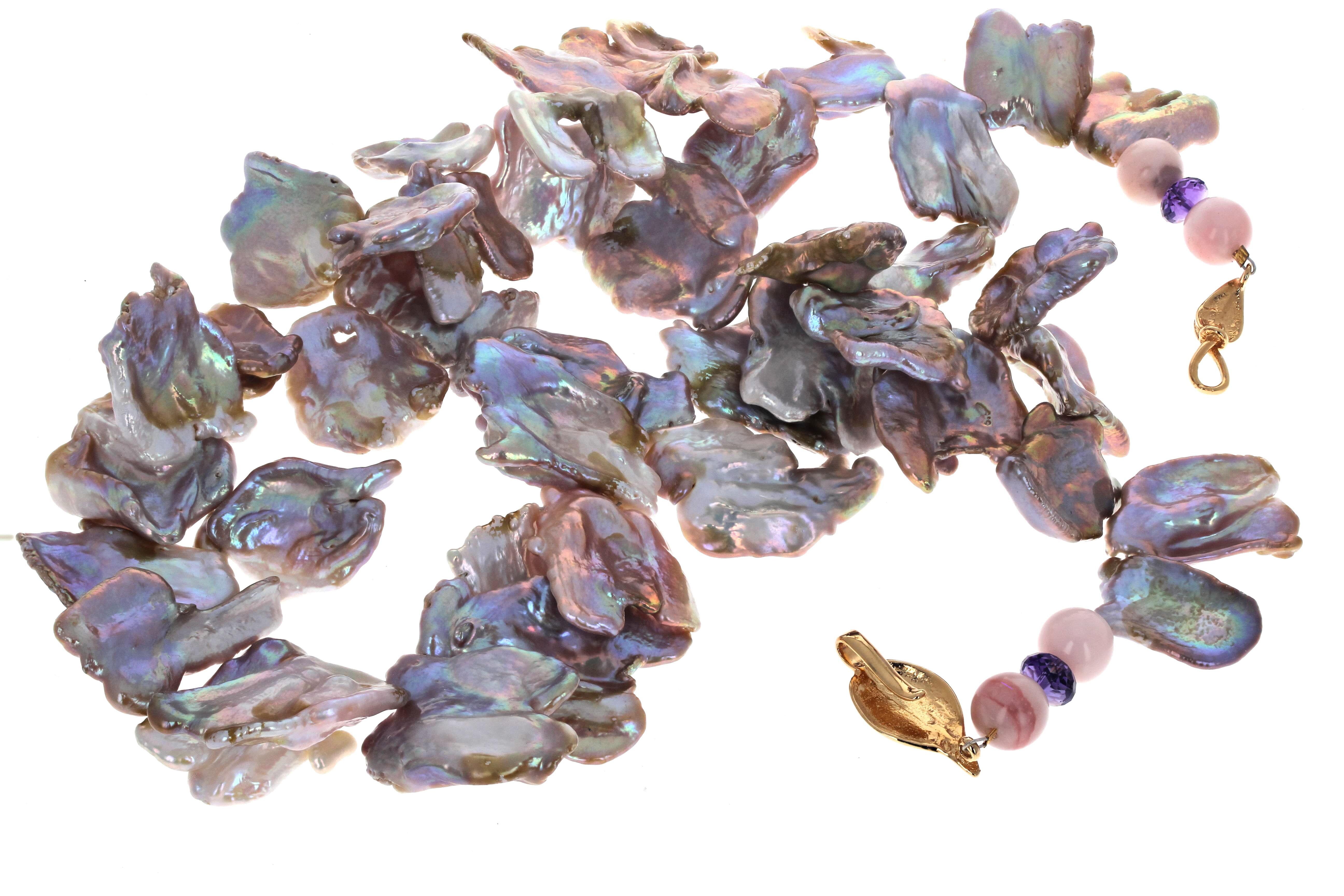 This gorgeous natural cultured fresh water Pearl necklace is 19 inches long.  The Pearls are all different natural colors that glow intensely when around your neck.  They are all approximately 24mm to 26mm. The little purplish brilliant gemstones at