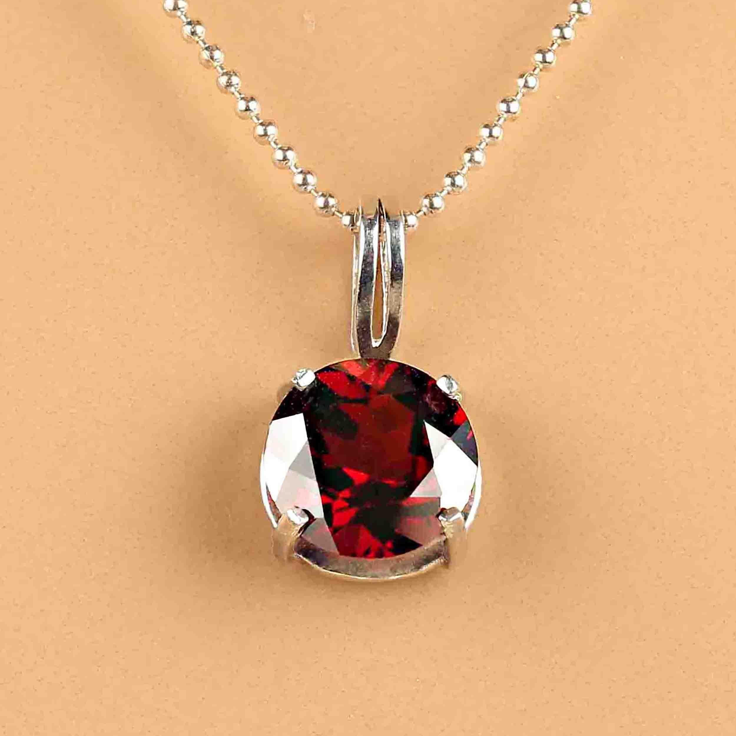Awesome round 10MM red Garnet set in a four prong Sterling Silver setting with a nice sized bail that will accommodate your favorite chain. 3/4 inches long and 3/8 inches wide. Garnet is the January birthstone.