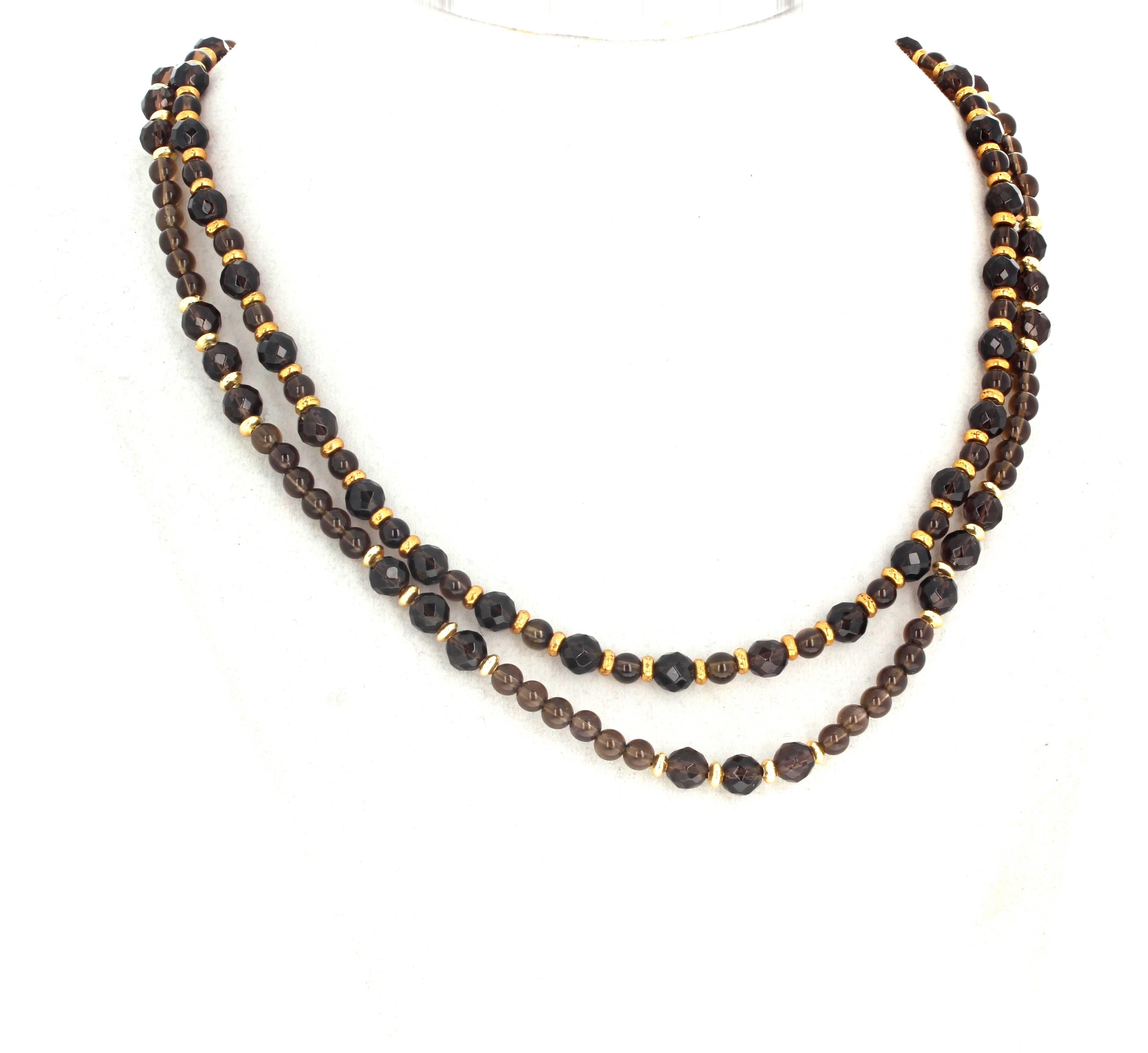 This simple double strand natural Smoky Quartz necklace is 17 inches long.  The larger gem cut highly polished Smoky Quartz are approximately 6mm and they are enhanced with tiny gold plated rondels in this elegant necklace.  The clasp is an easy to