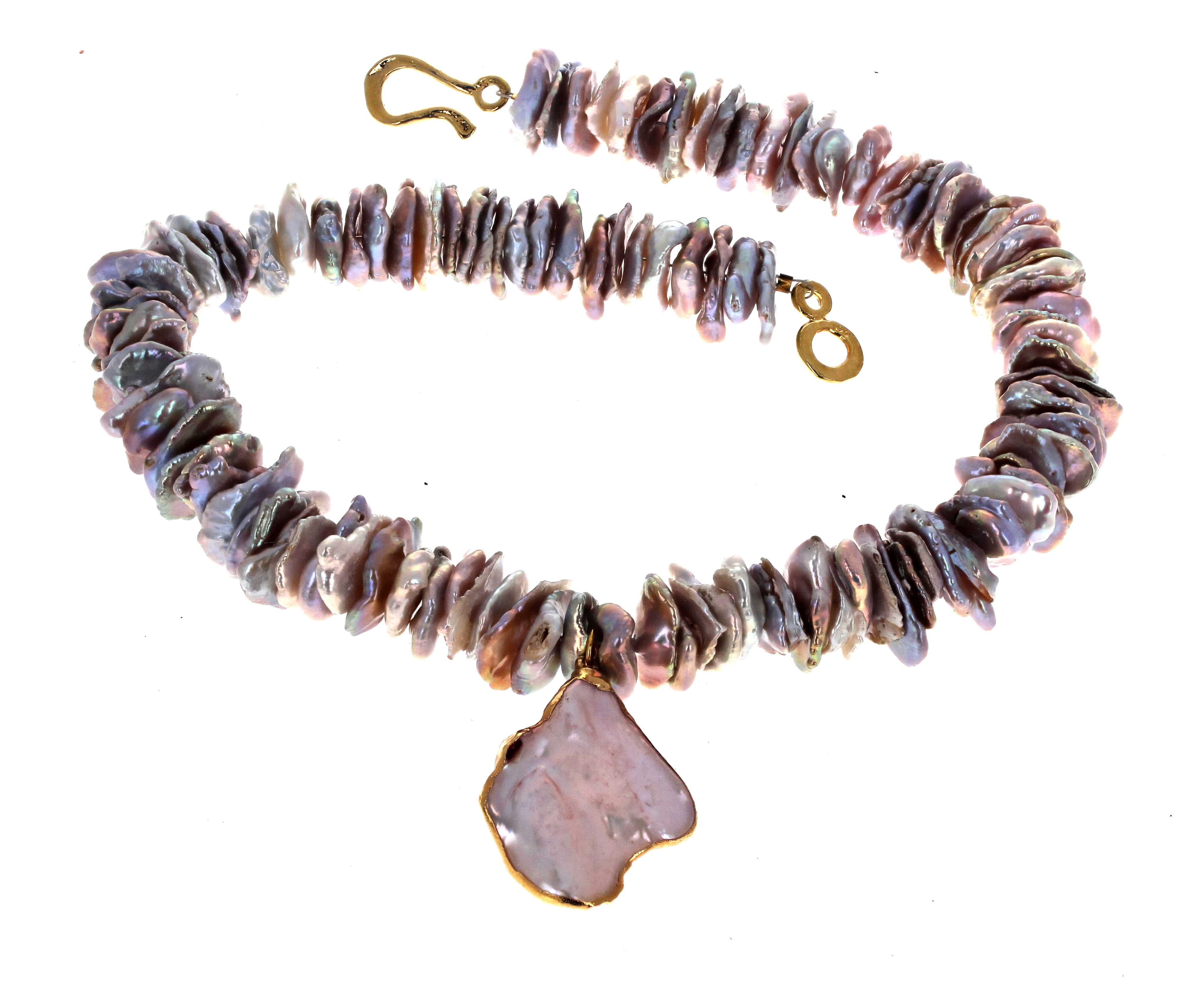 This is a fascinating necklace made from natural Pearl Shells.  They are all approximately 15mm.  The necklace is 17 inches long.  The center real Pearl Shell is  34mm x 28mm and glistens beautifully around your neck.  The clasp is an easy to use