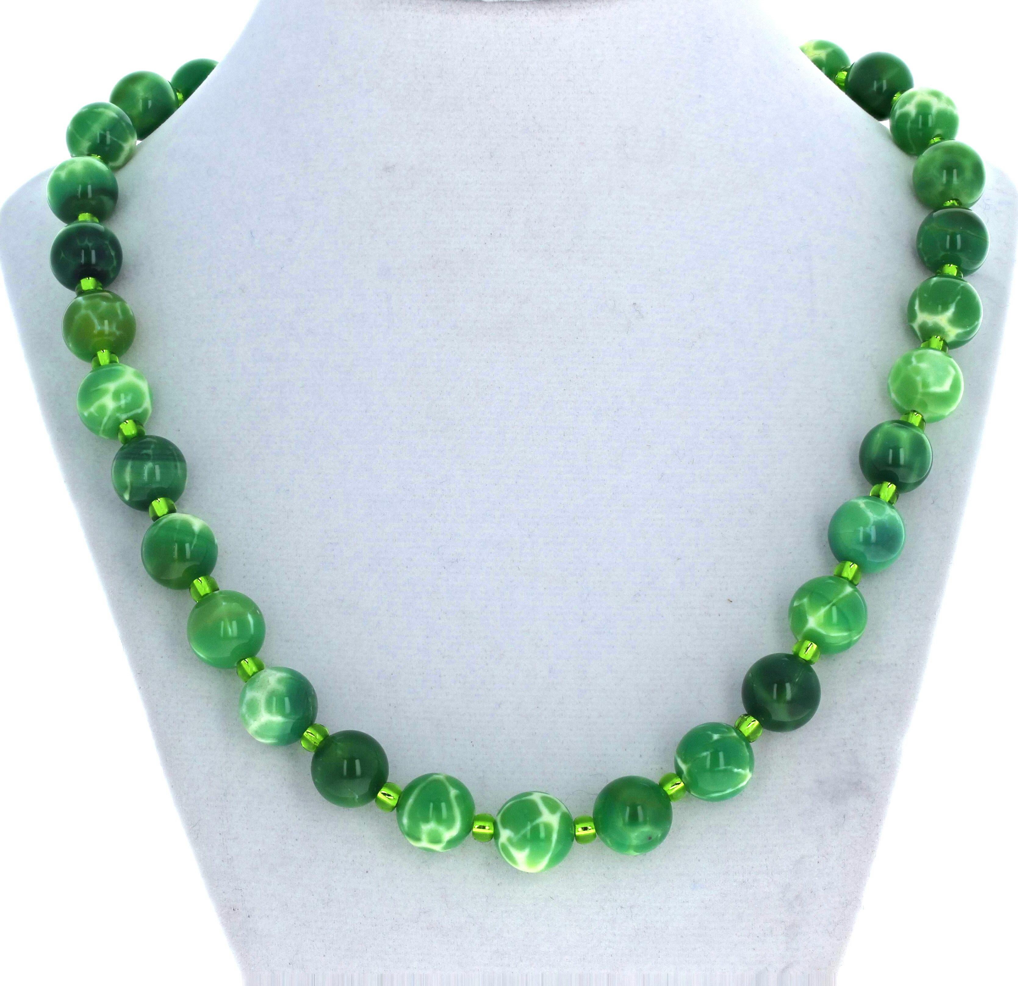This fascinating highly polished round green Chalcedony are 12mm.  They are enhanced with glittering green crystals.  The clasp is a gold plated easy to use hook clasp in this 19 inch long necklace.  