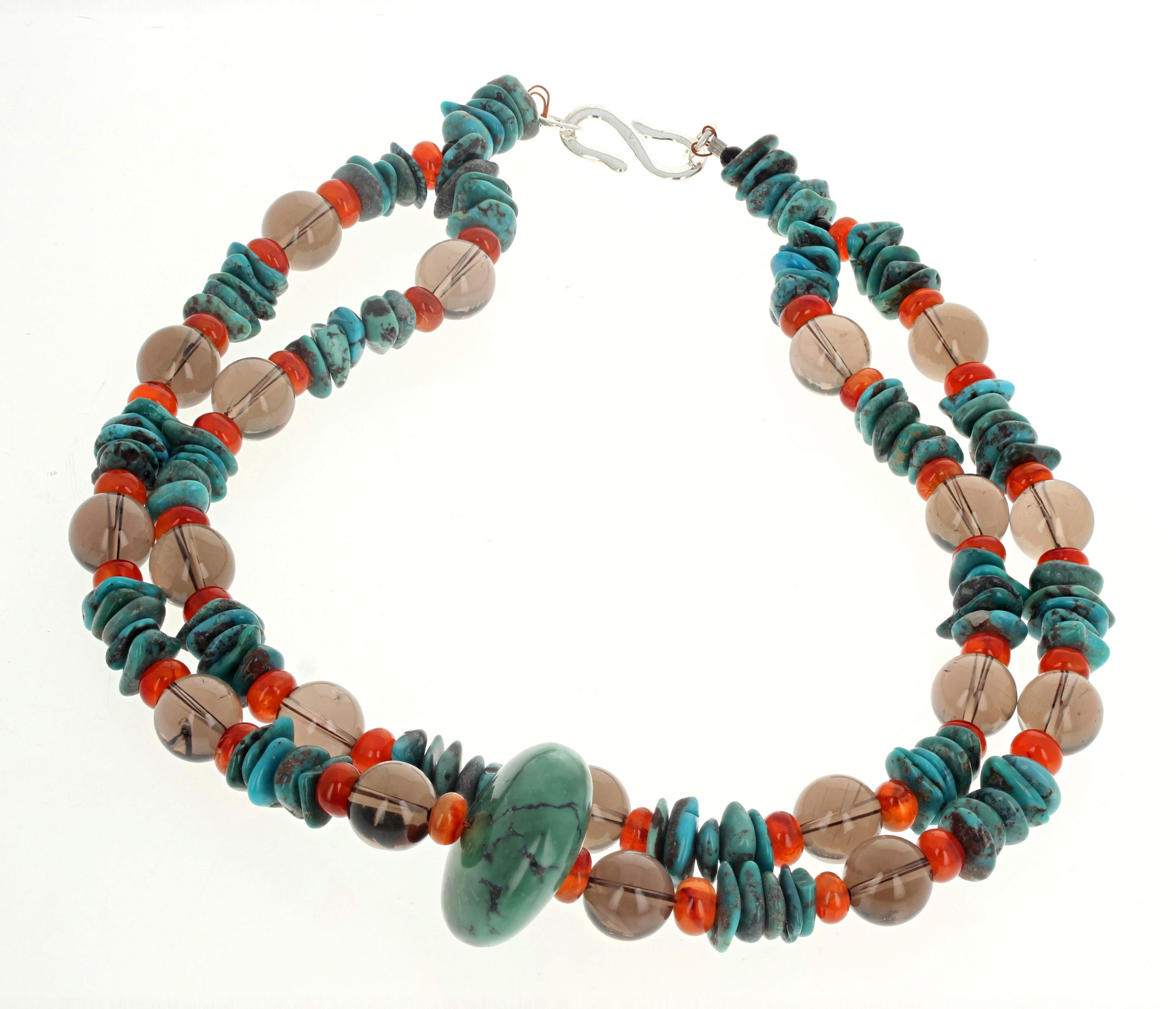 This fascinating artistic necklace is 17 1/2 inches long with a silver easy to use hook clasp.  The center Turquoise is 30mm, the natural real Smoky Quartz are 12 1/2mm, the Carnelian are approximately 8mm, and the small Turquoise are approximately