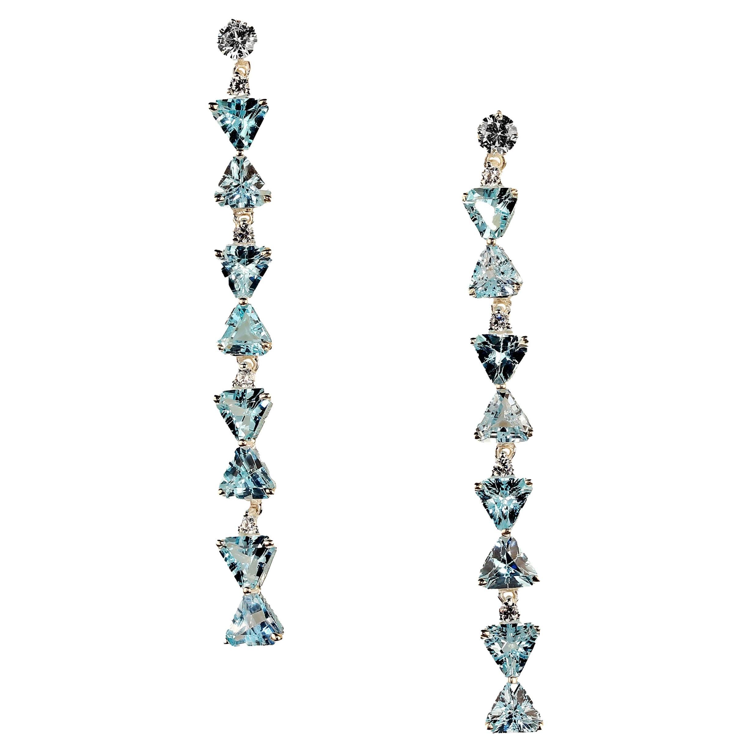 2.25 Inch dangle bedazzling Blue Topaz earrings.  These lines of kissing trillion Blue Topaz interspursed with genuine zircons are truly sparklers.  These Blue Topaz weigh 9.55ctw.  The genuine zircons weigh 1.29ctw. The gemstones are set in