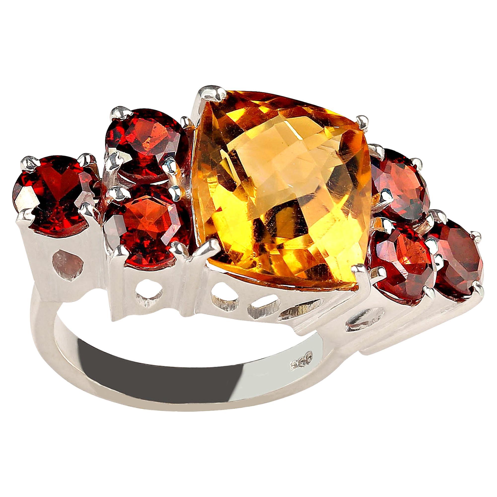 This is just the ring for cocktails and dinner.  Knuckle to knuckle pop and sparkle. Gorgeous sparkling golden antique cushion shaped Citrine with a checkerboard table is flanked with glittering red garnets, three and each side. The Citrine weighs