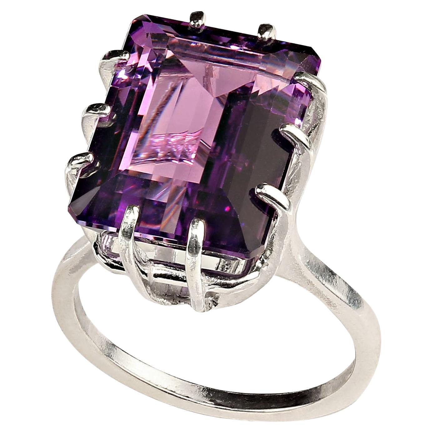 Sparkling Brazilian Emerald Cut Amethyst set in Sterling Silver prongs.  This 11.15 carat gem is medium tone with flashes of pink.  No changes by seller.  Sizable 8. Amethyst is the February birthstone and is said to protect from intoxication and