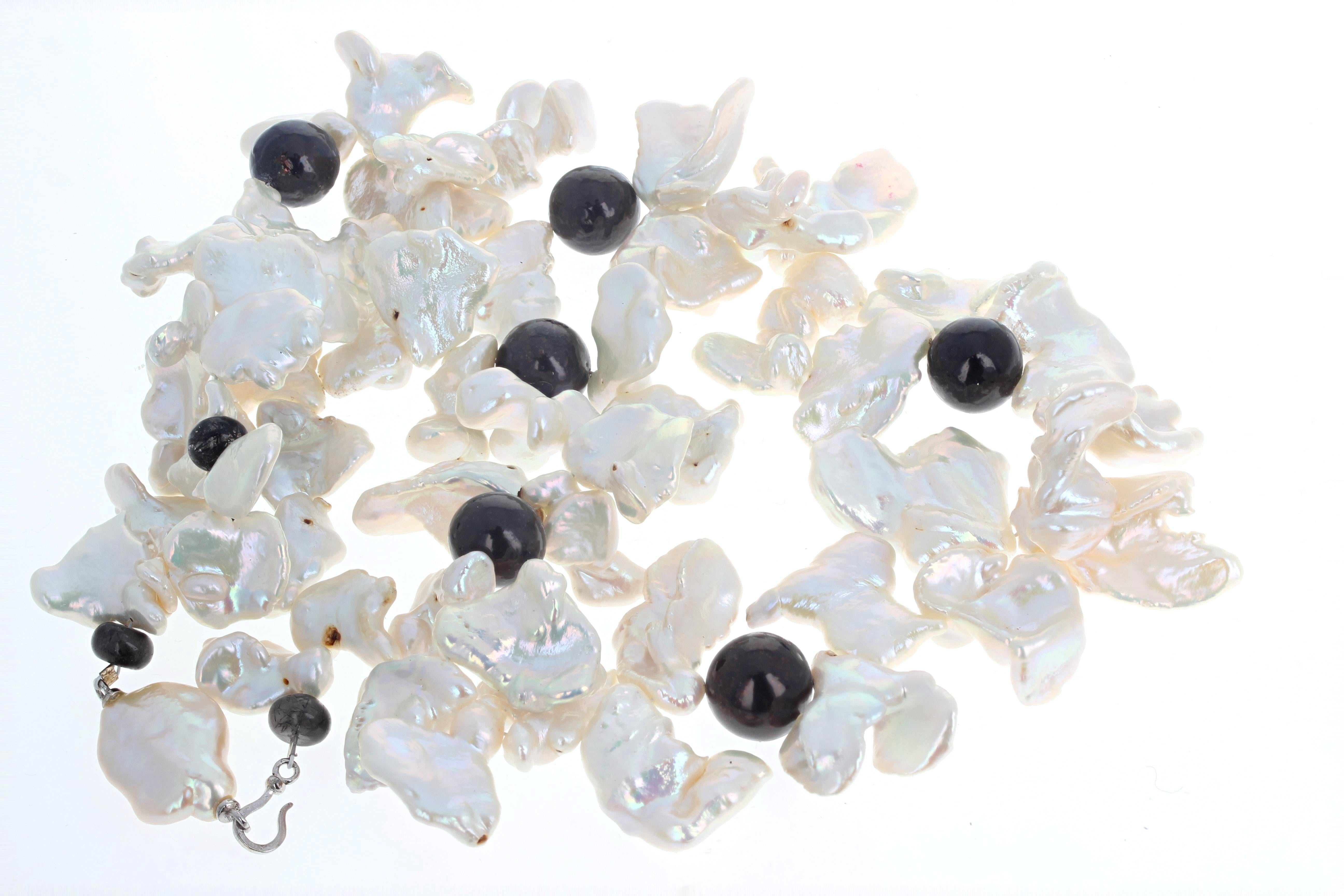 This glamorously beautiful necklace is 22 inches long.  The brilliant glistening white Keshi Pearls are all different sizes and shapes but the largest ones are approximately 30 x 20.  They are enhanced by these approximately 14mm brilliant dark