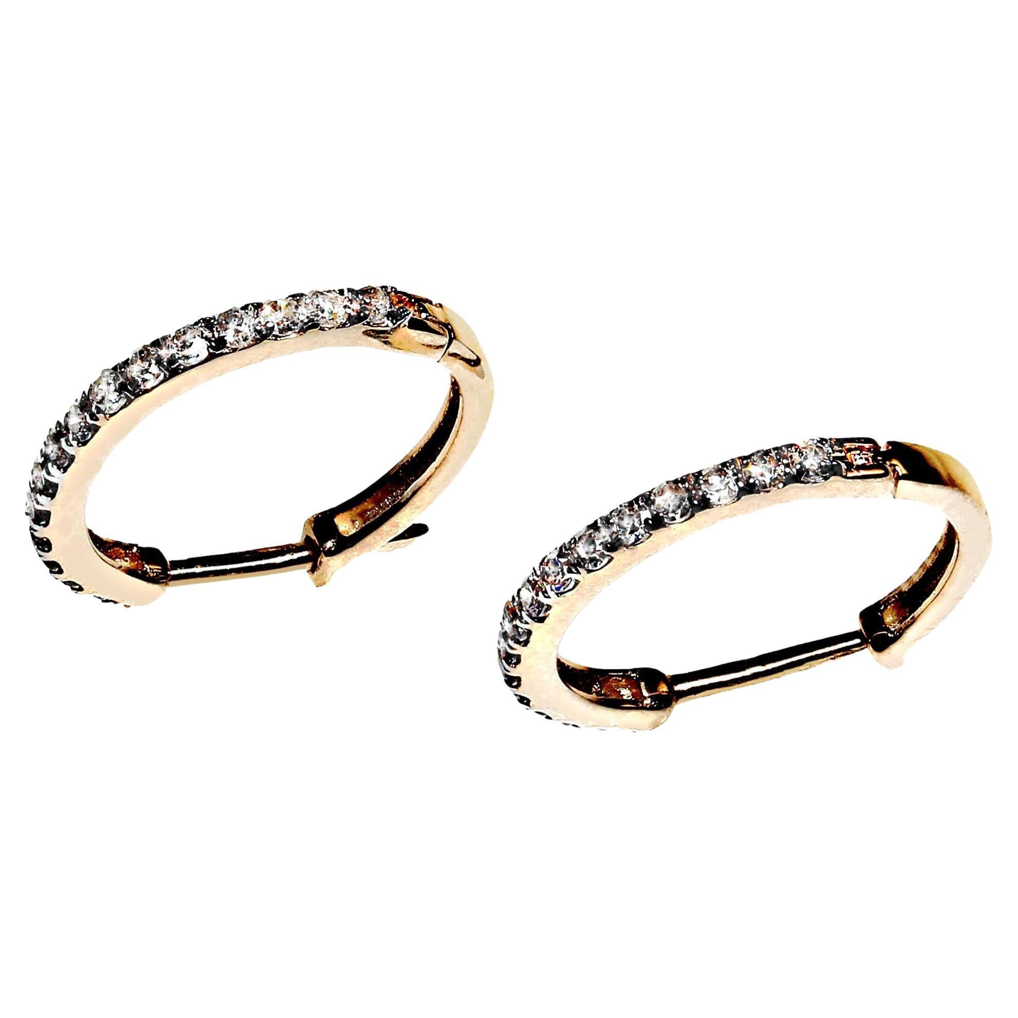 Classic, delicate Diamond and 14KT rich yellow gold one half inch hoop earrings. These classics are what the sparklers that everyone wants to wear.  They feature 0.17 carats of diamonds and 0.893 grams of 14KT yellow gold. They are hinged and have a