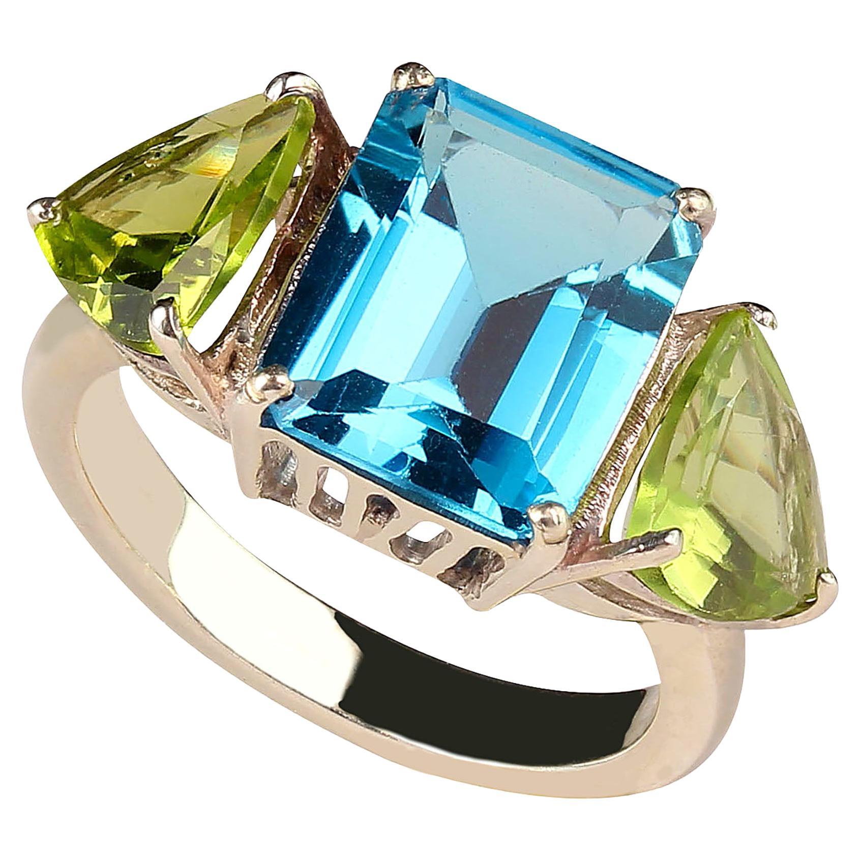 Sparkling favorite color of blue and green!  This sizable 6.5 sterling silver ring is a sure winner in Blue Topaz and green Peridot.  The emerald cut Blue Topaz, 4.4cts, is flanked by trillions of sparkling green Peridots, 4.4ctw. Wear this charmer
