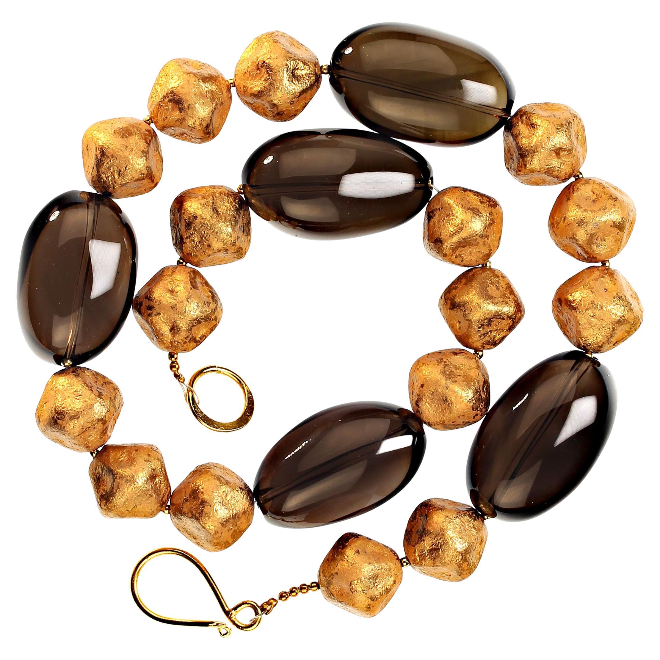 Custom made necklace of Beautifully Polished Oval Smoky Quartz Balanced with Gold tone Czech Beads. This necklace is a cool and sophicated look at 19.5 inches. The Smoky Quartz Ovals are approximately 30-34mm long and the Czech golden tone beads are