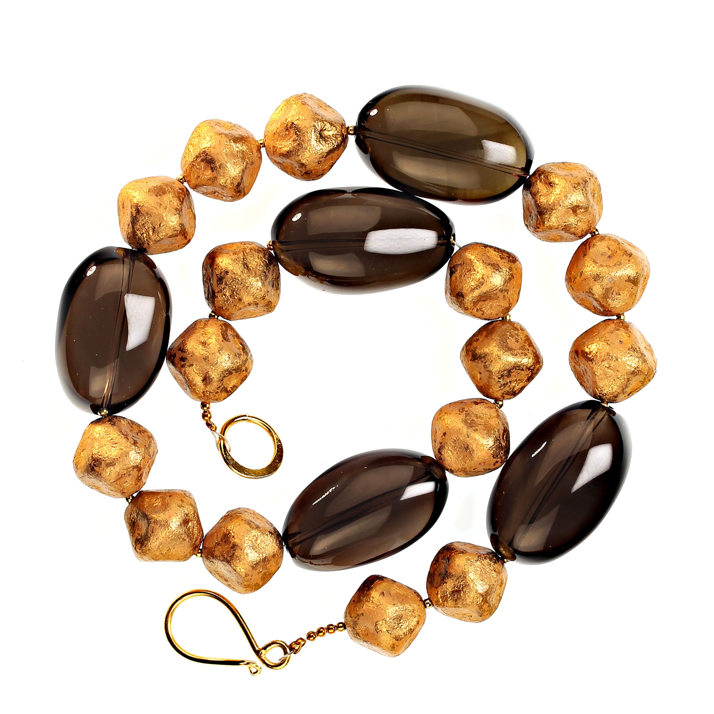 
Introducing the Custom-Made Smoky Quartz Necklace – a stunning accessory that effortlessly blends sophistication with natural beauty. This exquisite 19.5-inch necklace features beautifully polished oval smoky quartz gemstones, each measuring