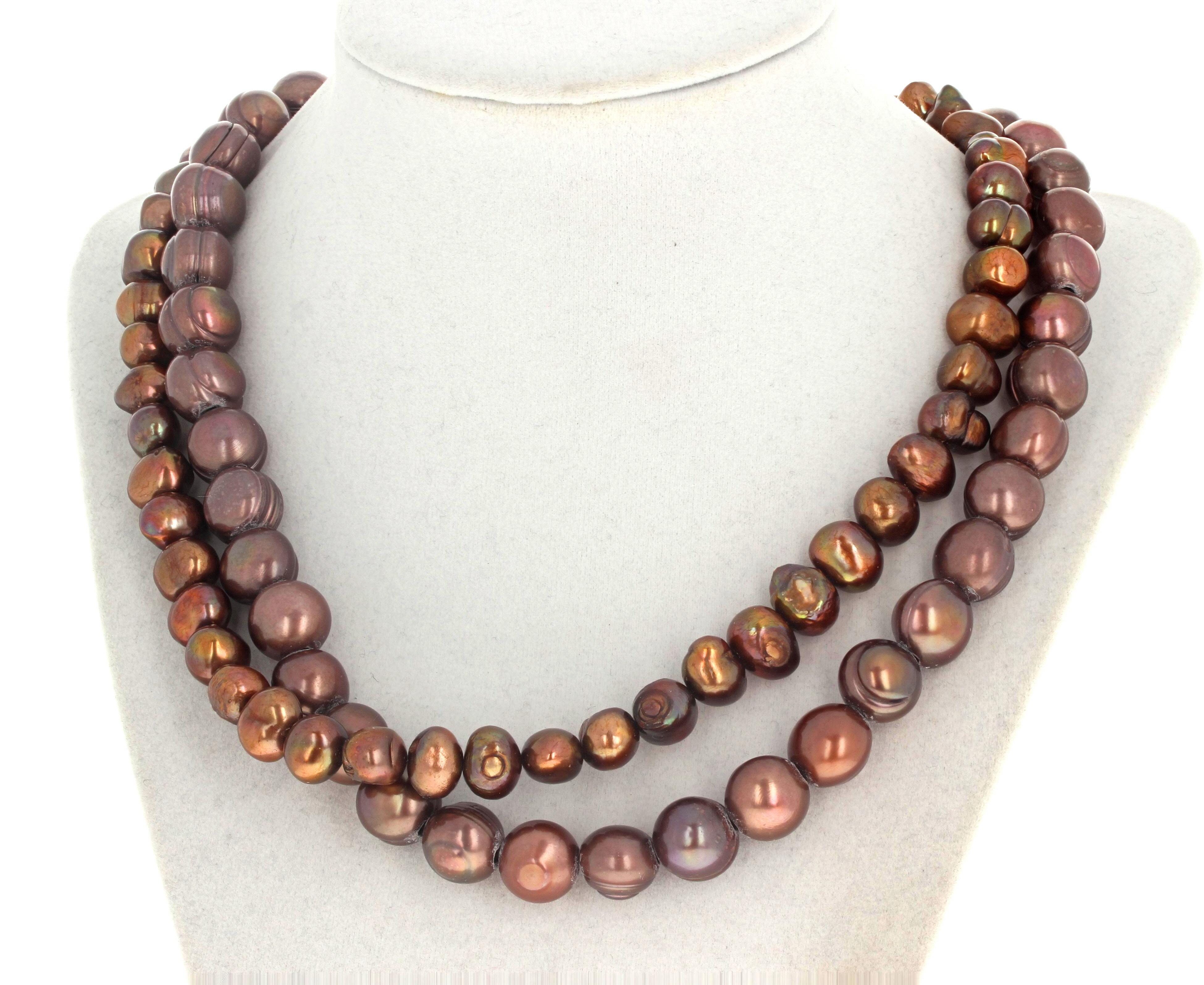 These fascinating colors of these natural cultured Pearls glow intensely on this double strand 19 inch long necklace.  They are multi-color colors and the largest are approximately 12 1/2mm round.  The clasp is and easy to use gold plated hook