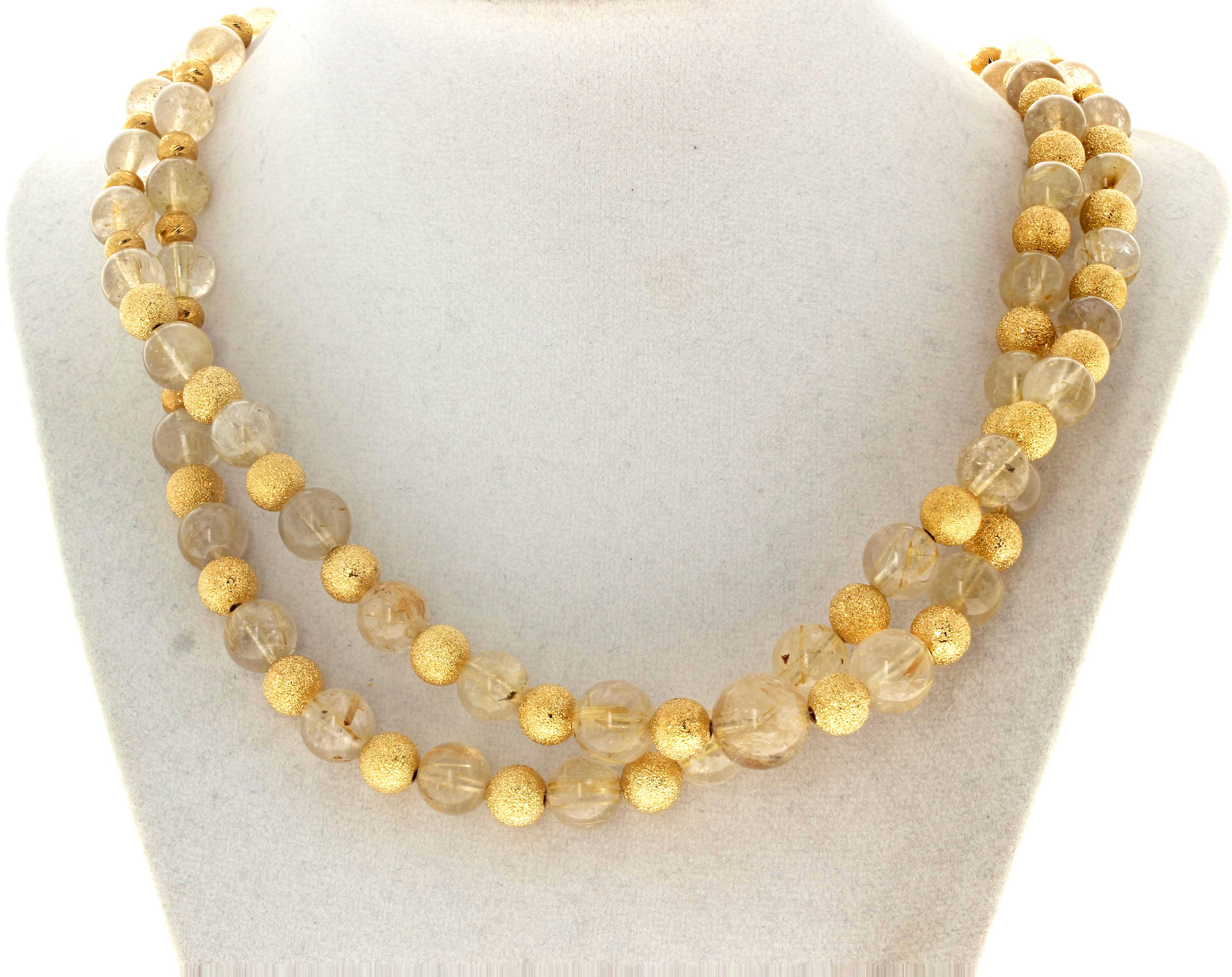 This fascinating beautiful double strand of glowing natural rutilated Quartz - largest approximately 13mm - is enhanced with large beautiful real gold plated rondels - largest approximately 8mm - in this 19 inch long necklace.  The clasp is and easy