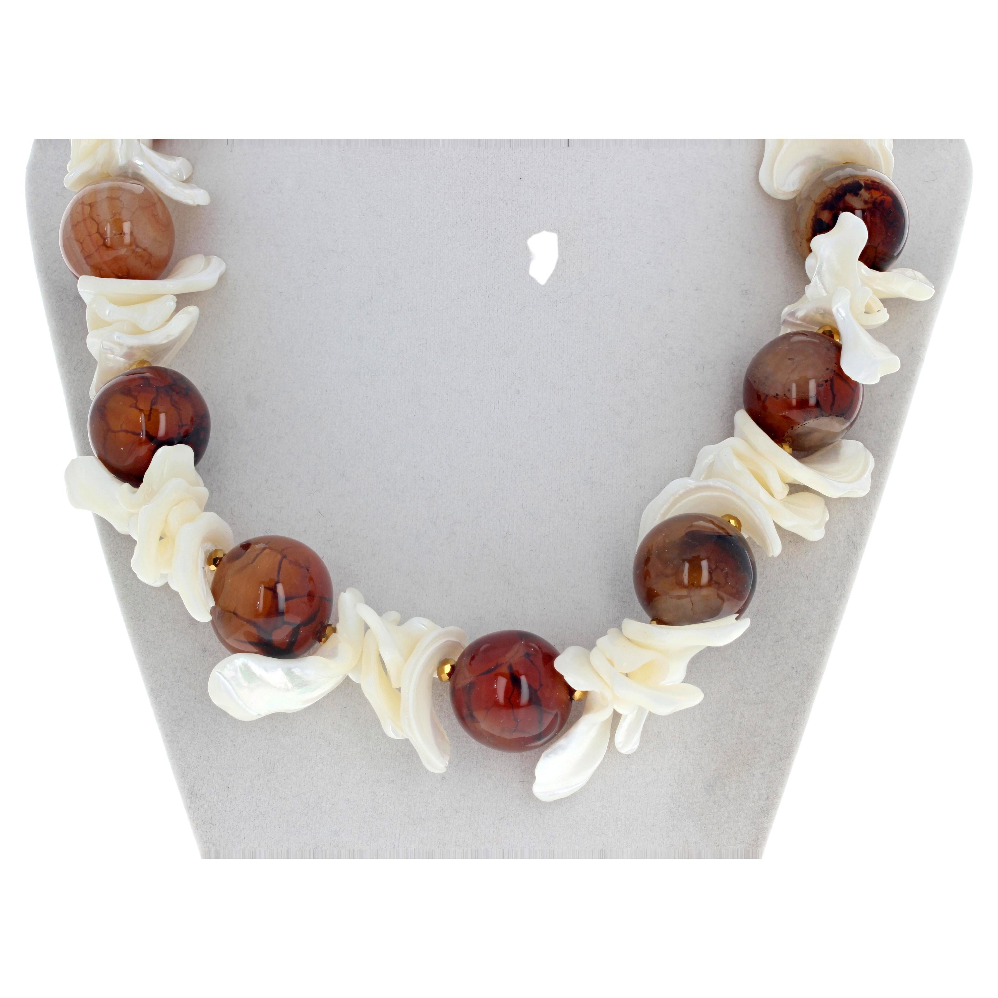 These beautifully highly polished natural translucent 21mm Agates glow different colors intensely in this 20 inch long necklace.  The flippy floppy beautiful white natural Peal Shells have no sharp edges and are comfortable and easy to wear.  The