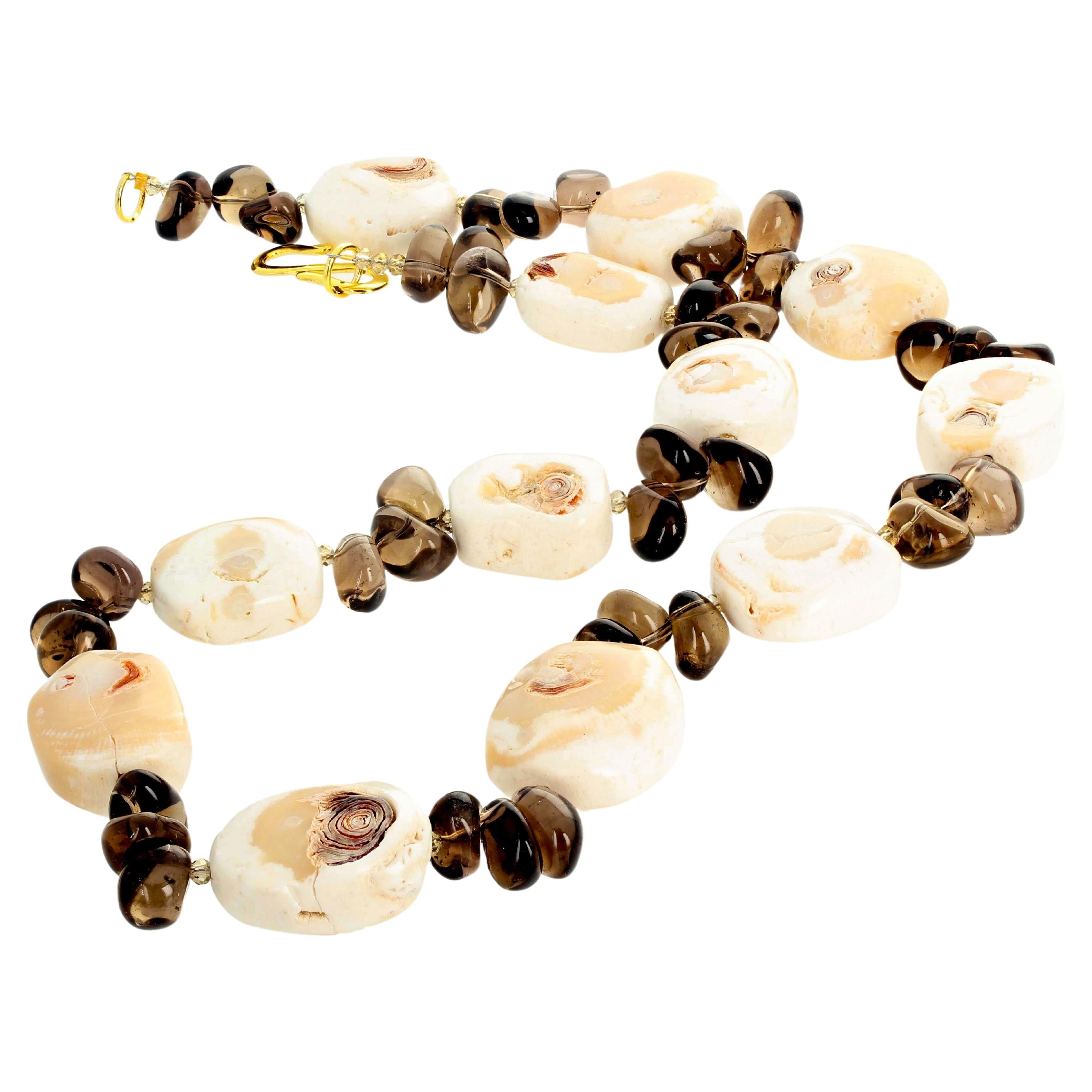 Natural Coral enhanced with briolets of natural real Smoky Quartz gem stones swing beautifully in this lovely 24 inch long necklace with gold plated easy to use hook clasp.  This elegantly dramatic necklace is ready for all occasions.